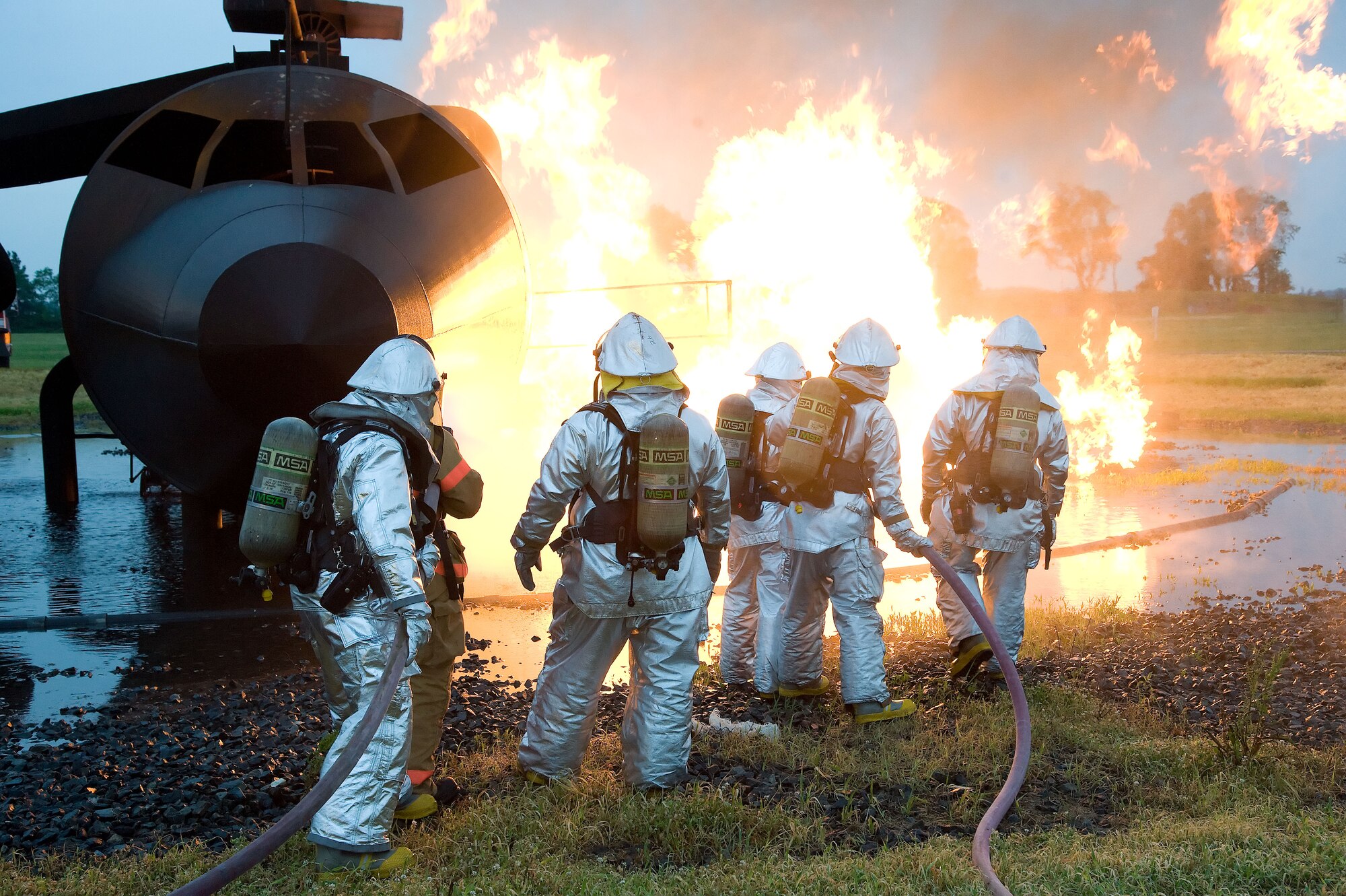 Firefighters from the 436th Civil Engineer Squadron extinguish a simulated airplane fire June 12, 2012 at Dover Air Force Base, Del. The members of the fire protection flight regularly train for real world emergencies.  (U.S. Air Force photo by Adrian R. Rowan)