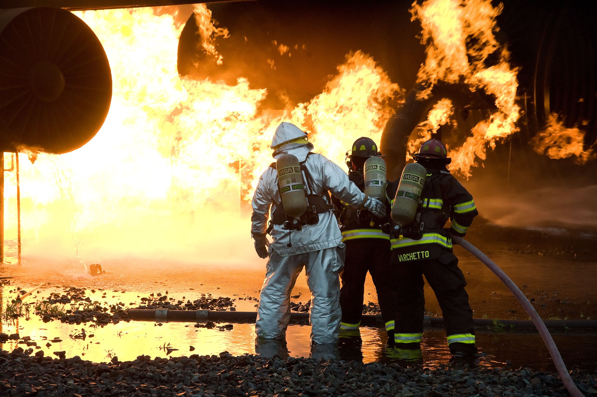 Firefighters from the 436th Civil Engineer Squadron extinguish a simulated airplane fire June 12, 2012 at Dover Air Force Base, Del. The members of the fire protection flight regularly train for real world emergencies.  (U.S. Air Force photo by Adrian R. Rowan)