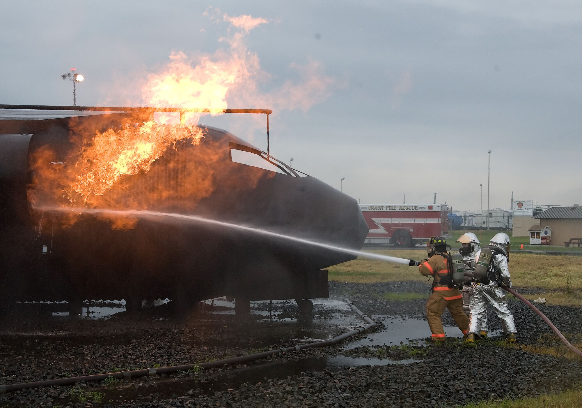 Firefighters from the 436th Civil Engineer Squadron extinguish a simulated airplane fire June 12, 2012 at Dover Air Force Base, Del. The members of the fire protection flight regularly train for real world emergencies.  (U.S. Air Force photo by Adrian R. Rowan)