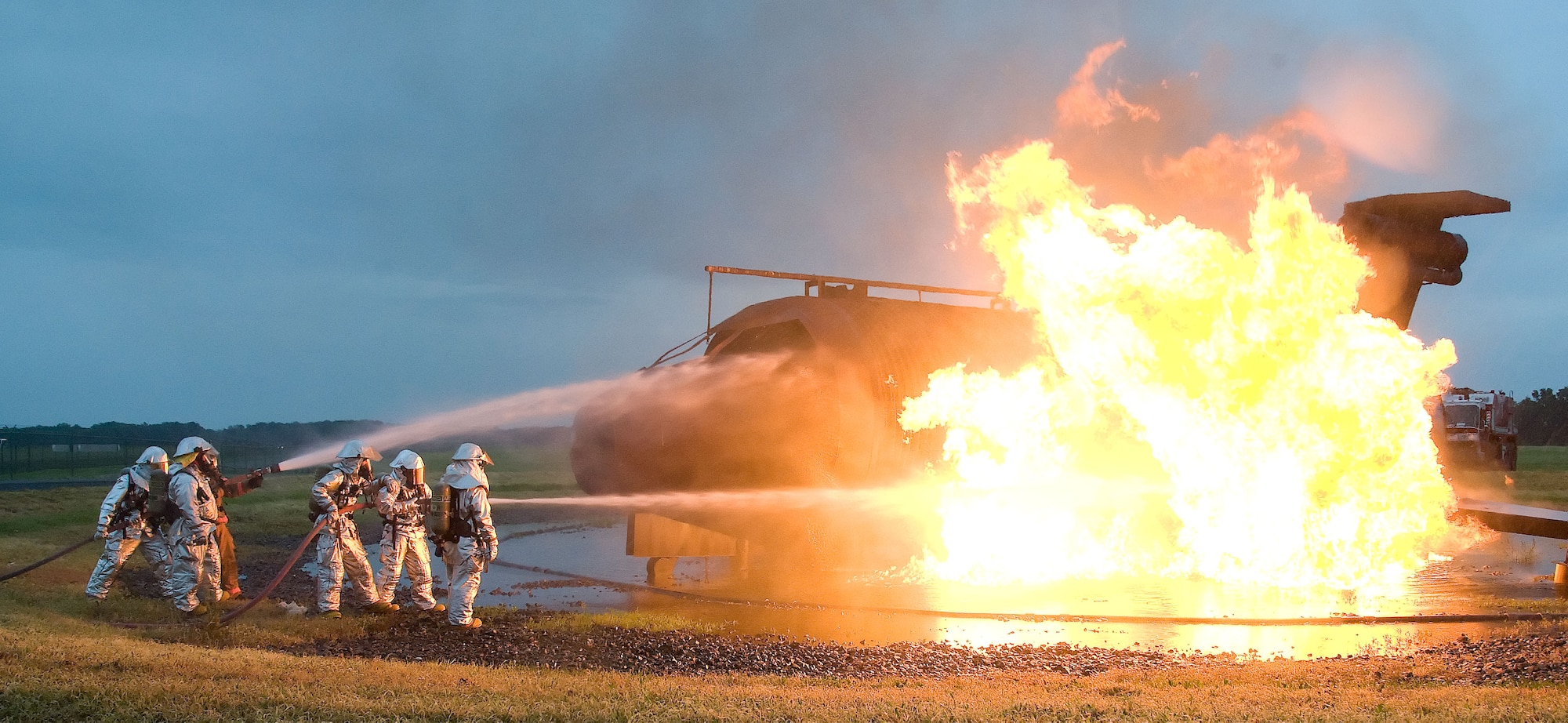 Firefighters from the 436th Civil Engineer Squadron extinguish a simulated airplane fire June 12, 2012 at Dover Air Force Base, Del. The members of the fire protection flight regularly train for real world emergencies.  (U.S. Air Force photo by Adrian R. Rowan)