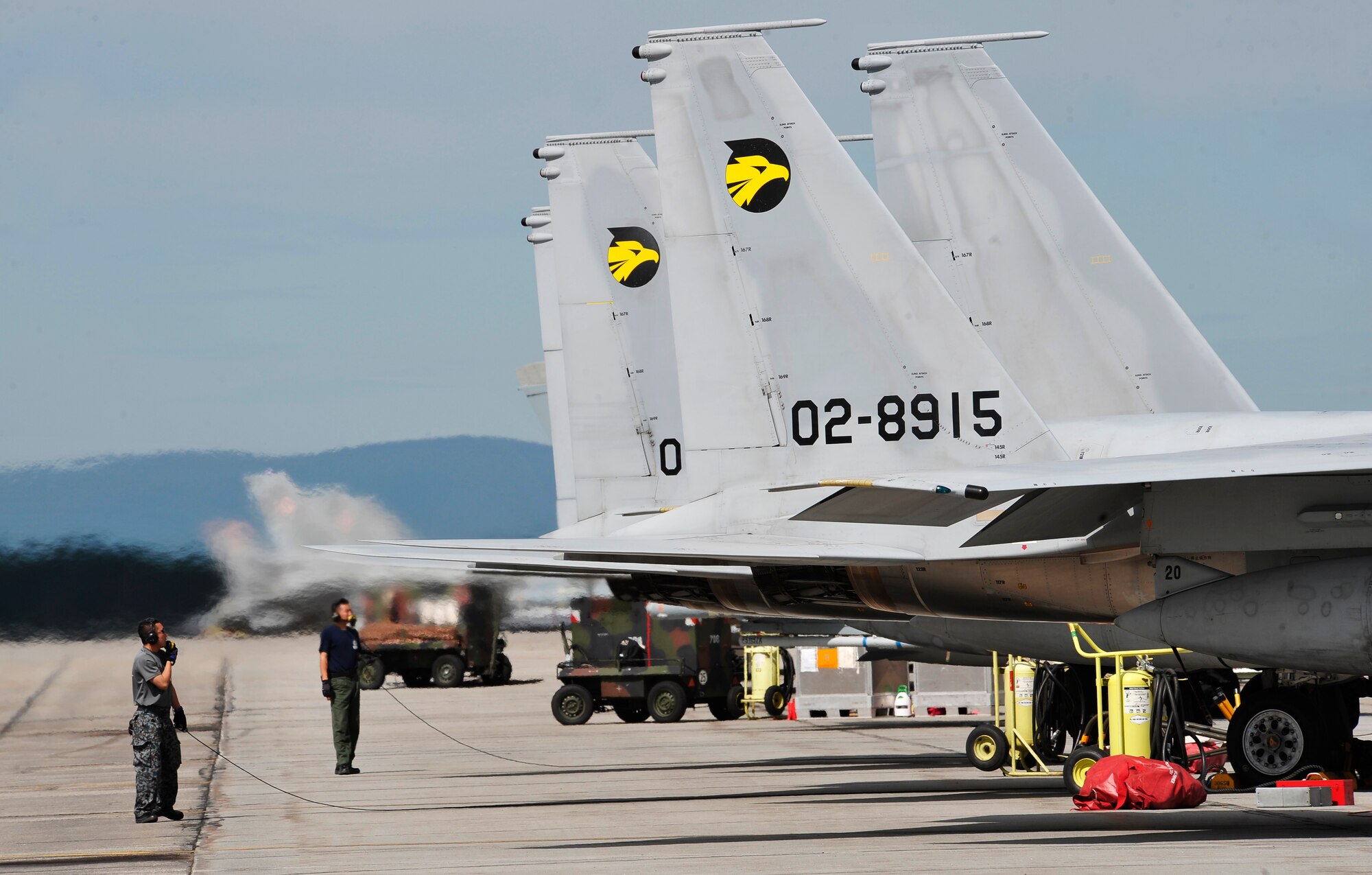 A Japanese Self Defense Force crew chief communicates to the pilot in a F-15J Eagle prior to take-off during RED FLAG-Alaska 12-2 June 11, 2012, Eielson Air Force Base, Alaska.  The work completed by crew chiefs provide mission-capable aircraft for pilots so they can provide air support, serving as a vital role in the overall RF-A mission.  (U.S. Air Force photo/Staff Sgt. Miguel Lara III)