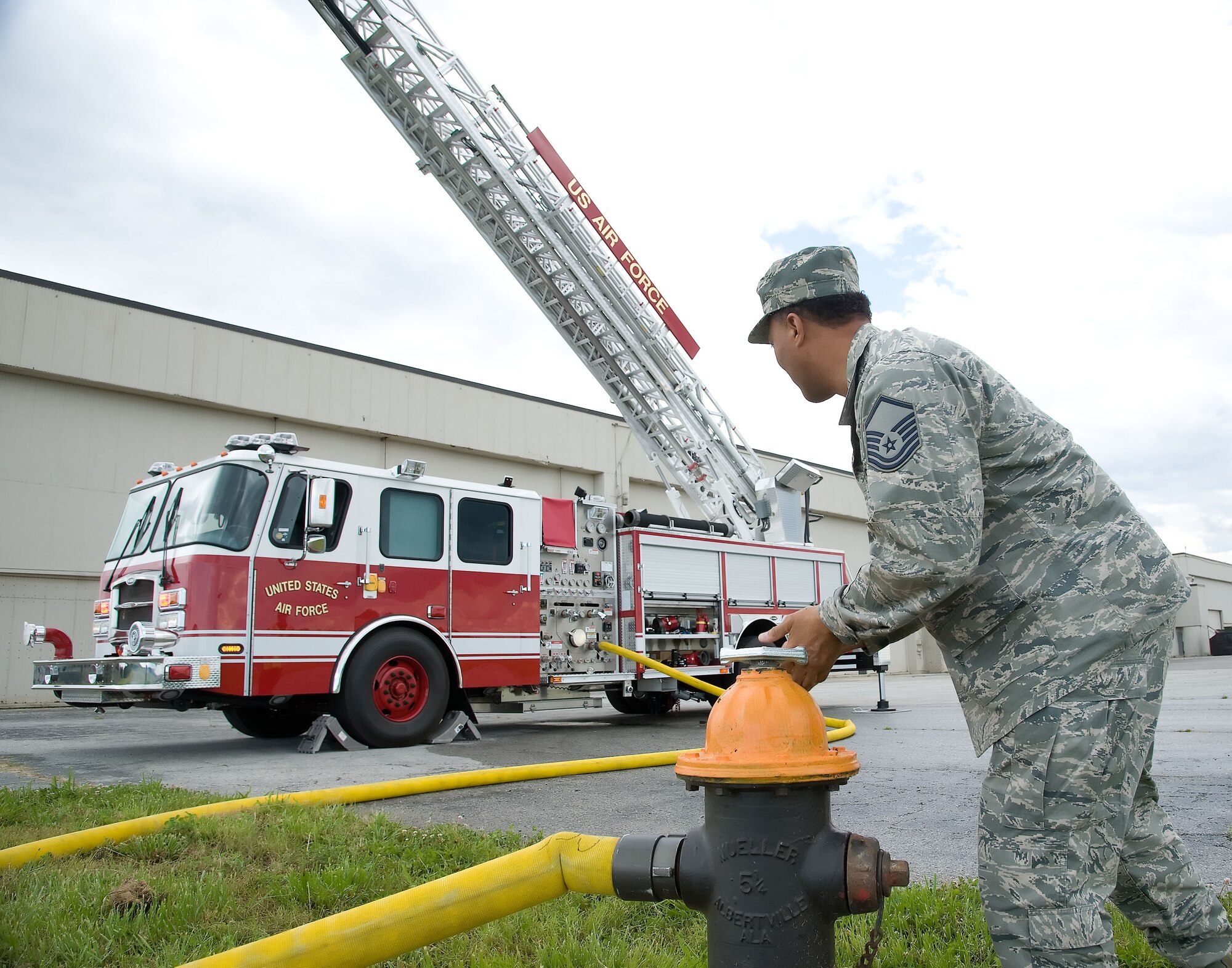 Master Sgt. Michael Harris, assistant chief of operations with the 512th Civil Engineer Squadron, turns on a fire hydrant June 6, 2012 at Dover Air Force Base, Del. The members of the fire protection flight regularly train for real world emergencies.  (U.S. Air Force photo by Adrian R. Rowan)