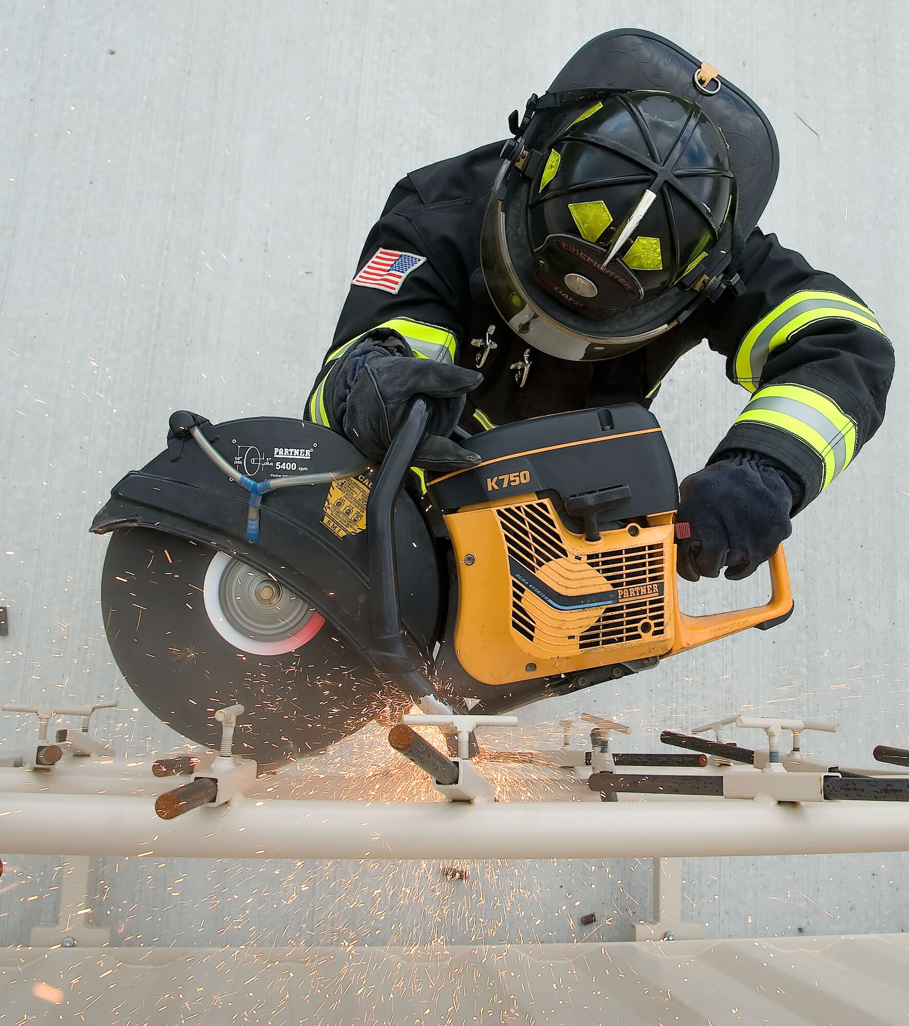 Staff Sgt. David Smith, firefighter crew chief with the 436th Civil Engineer Squadron, practices with a K-12 saw used for forcible entry techniques June 6, 2012 at Dover Air Force Base, Del. The members of the fire protection flight regularly train for real world emergencies.  (U.S. Air Force photo by Adrian R. Rowan)