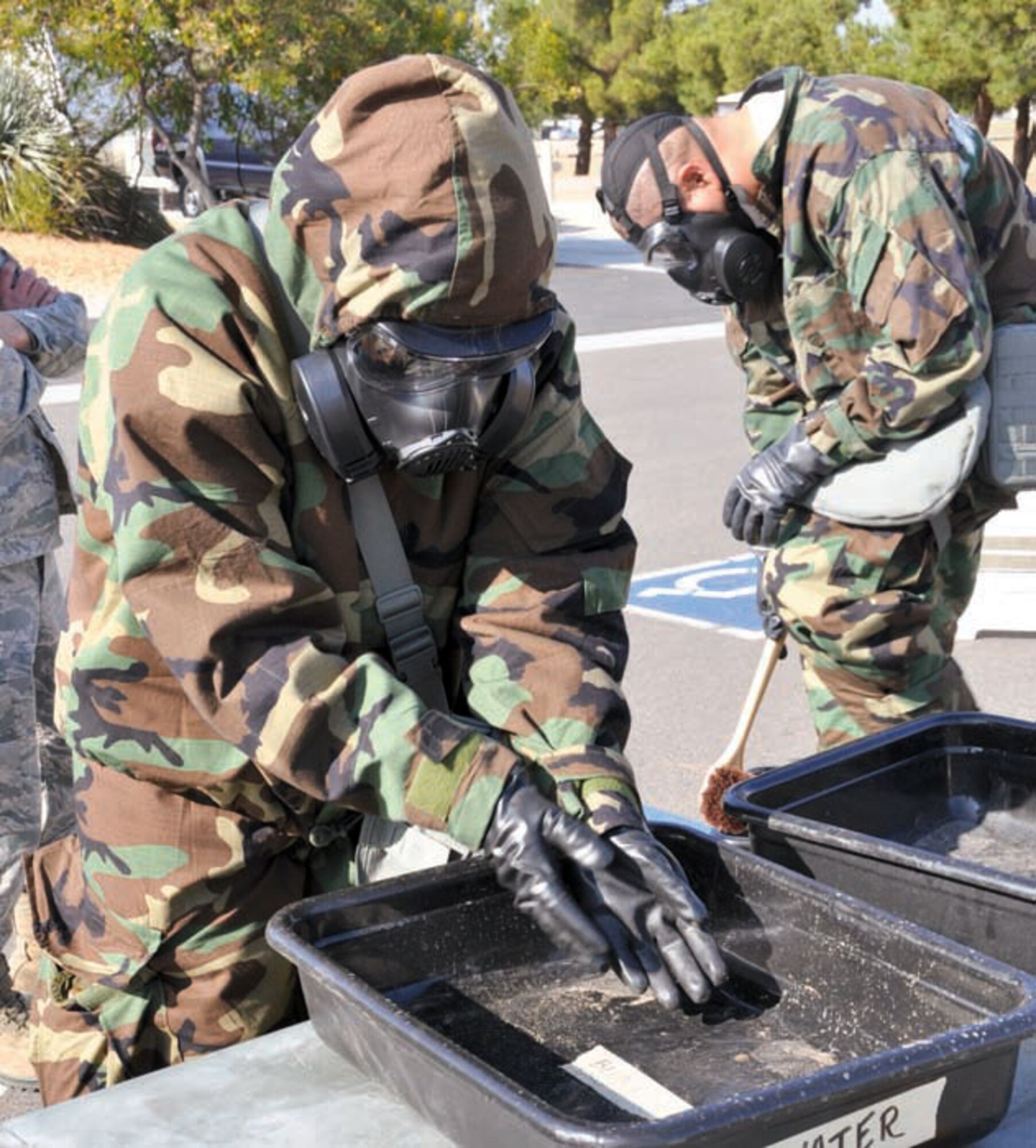 March Team member simulates passing through a decontamination line during Chemical, Biological, Radiological, Nuclear and highyield Explosives, or CBRNE training, Feb. 25. This type of training will enhance the members ability to conduct day-to-day operations while in a contaminated environment. (U.S. Air Force photo by Megan Crusher)