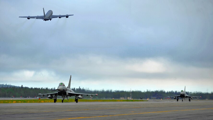 Two German air force Eurofighter Typhoons taxi the runway as a KC-135R Stratotanker launches from the runway during Red Flag-Alaska 12-2 at Eielson Air Force Base, Alaska, June 11, 2012. The KC-135R Stratotanker is assigned to the 22nd Air Refueling Wing at McConnell Air Force Base, Kan. (U.S. Air Force photo/Staff Sgt. Miguel Lara III) 