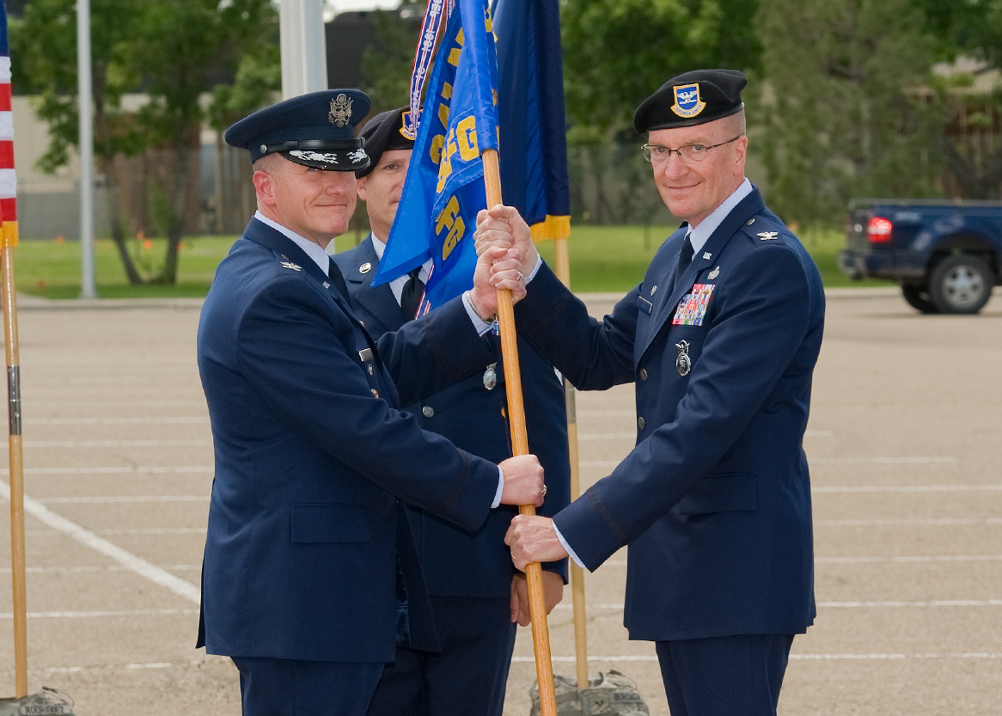 Col. David Lynch, right, accepts command of the 341st Security Forces Group from Col. Robert Stanley, 341st Missile Wing vice commander.  Chief Master Sgt. Timothy McLaughlin, 341st Security Forces Group security forces manager looks on.  (U.S. Air Force photo/Beau Wade) 