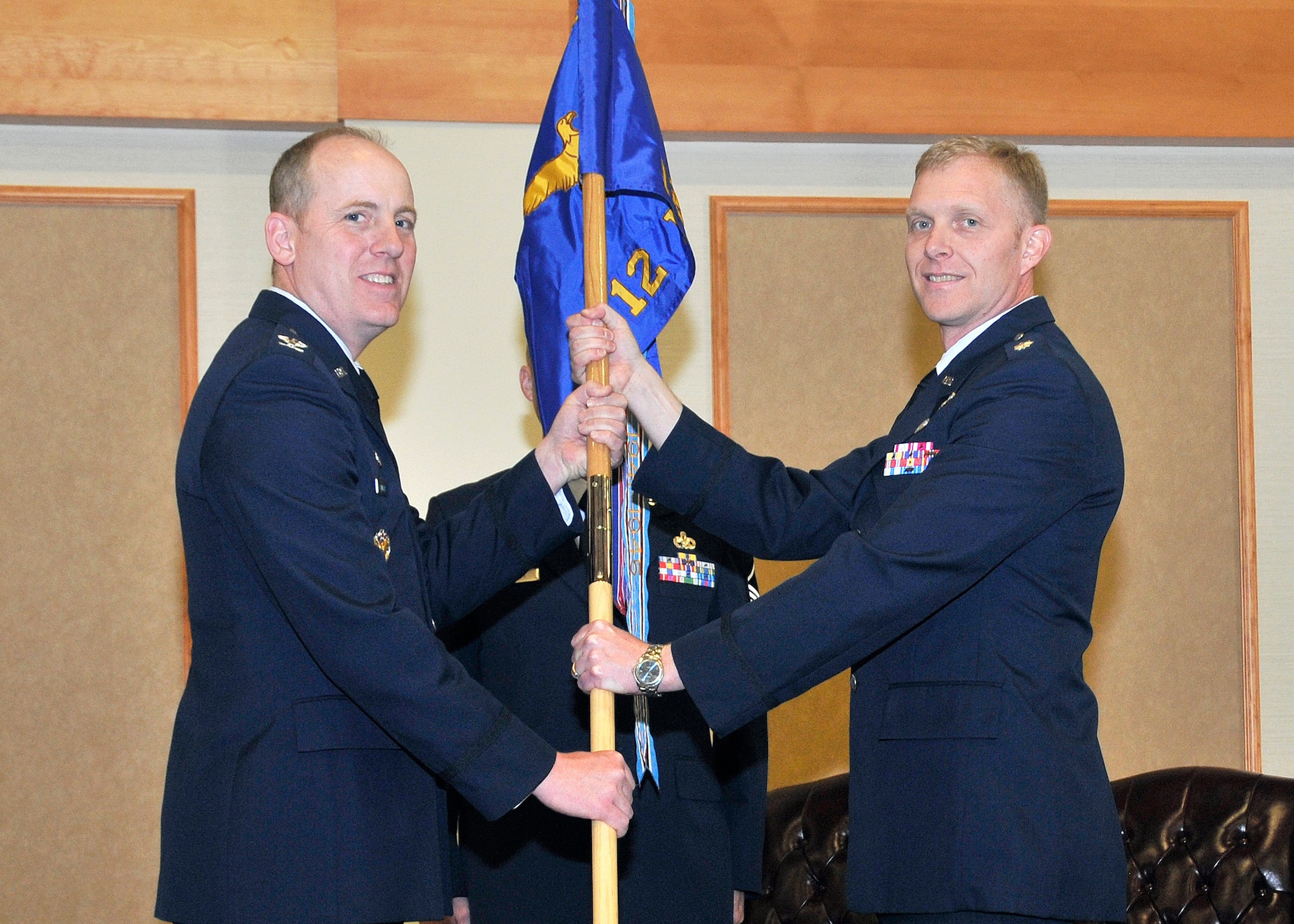 Lt. Col. Jeffrey Voetberg, right, accepts command of the 12th Missile Squadron from Col. Edward Rimback, 341st Operations Group commander, at the Grizzly Bend June 12.  (U.S. Air Force photo/John Turner)