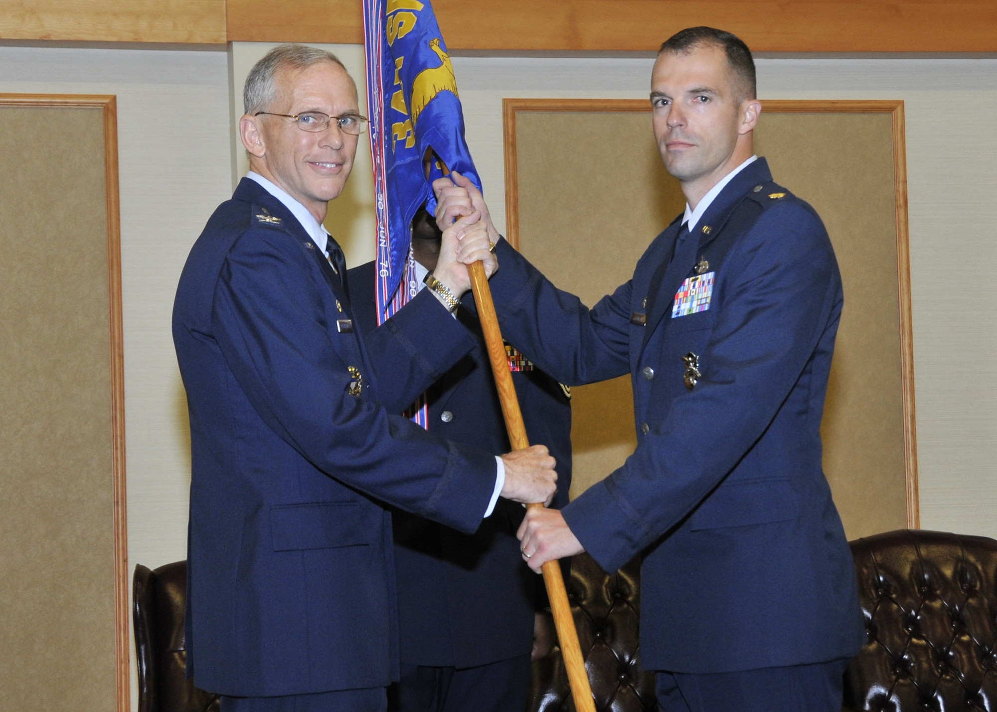 Maj. Steven Bauman, right, accepts command of the 341st Security Forces Squadron from Col. Robert Mendenhall, 341st Security Forces Group commander, June 11 at the Grizzly Bend.  (U.S. Air Force photo/John Turner)