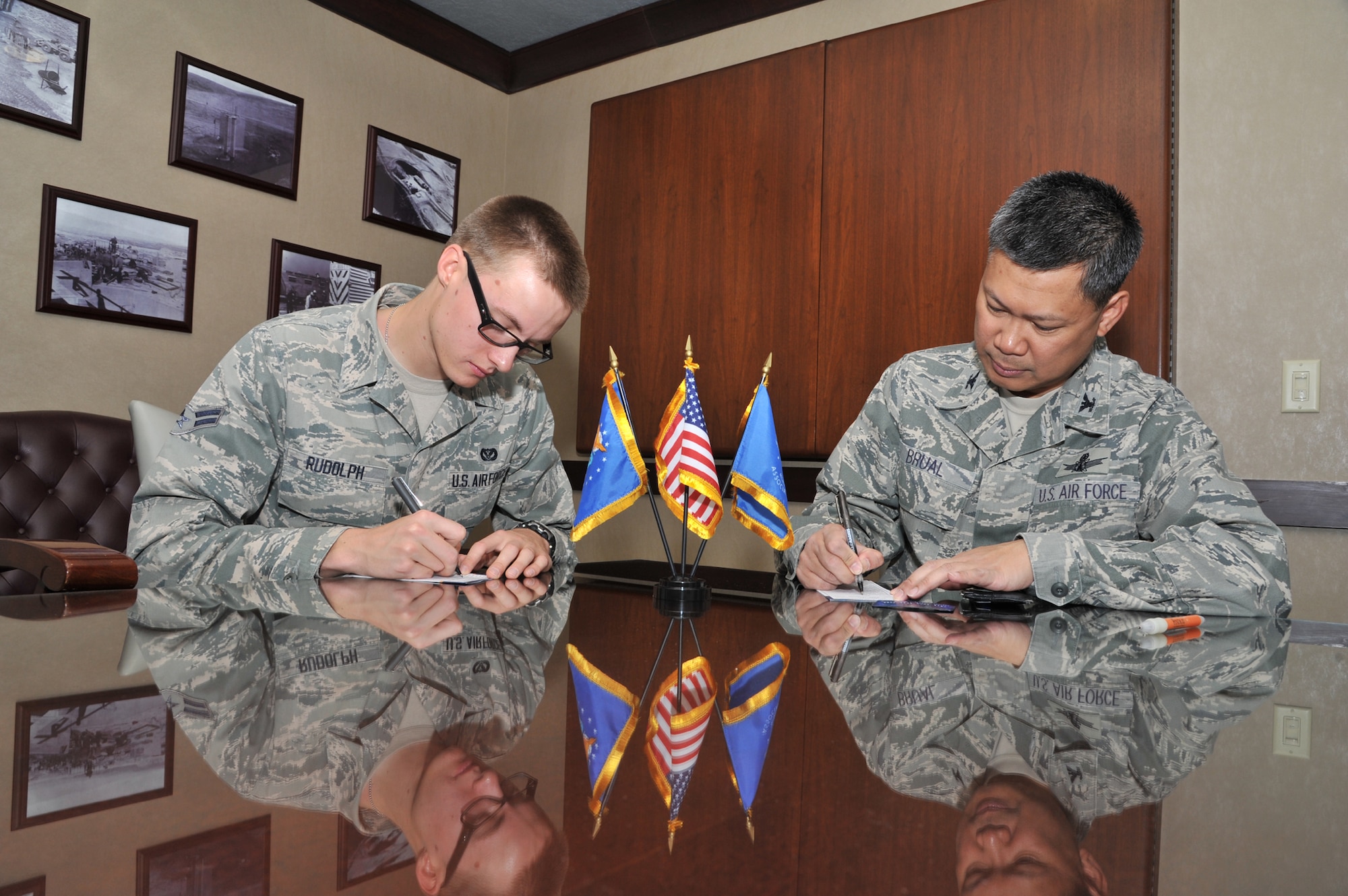 Airman 1st Class Rene Rudolph, 819th RED HORSE Squadron member, and Col. H.B. Brual, 341st Missile Wing commander, prepare to sign membership applications to join the Air Force Sergeants’ Association on June 7.  The AFSA’s next meeting is scheduled for June 29 at 11 a.m. at the Grizzly Bend.  (U.S. Air Force photo/ John Turner)