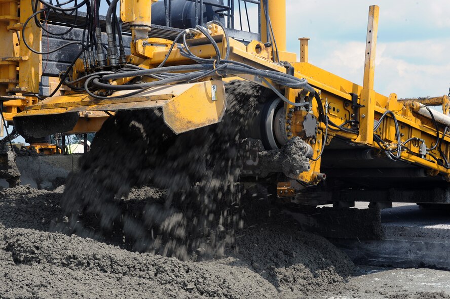 A conveyer belt dispenses cement for runway construction on Seymour Johnson Air Force Base, N.C., June 13, 2012. Due to signs of wear and tear, 1,206 slabs of concrete are being replaced. (U.S. Air Force photo/Airman 1st Class John Nieves Camacho/Released)