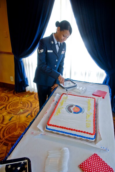 Senior Airman Terisha Vaughn, 728th Air Control Squadron weapons director, Eglin Air Force Base, Fla., cuts a cake June 8 after the graduation of the 107th ACS enlisted weapons directors. Vaughn received the distinct honor of being the 500th student to graduate from the program since its start in August 2000.  (U.S. Air Force photo by Senior Airman C.J. Hatch)