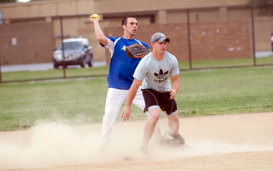 Scott Steinbeck, right, 11th Civil Engineer Squadron second baseman, safely skids to
second base as Mike Mudd, left, Air Force District Washington second baseman, tries to
make the play during an intramural softball game between 11 CES and AFDW near the
West Fitness Center at Joint Base Andrews, Md., on June 6. (photo/Bobby Jones)
