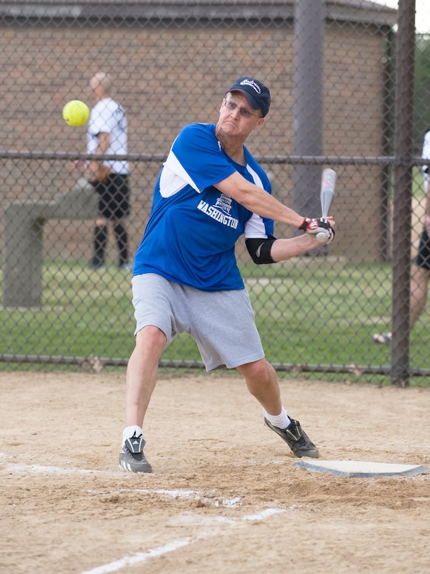 Jeff Stephenson, Air Force District Washington right center, swings for a base hit
during an intramural softball game between the 11th Civil Engineer Squadron and
AFDW on June 6. The 11 CES rallied to win the game in the sixth inning against
AFDW, 14 to 9. (photo/Bobby Jones)