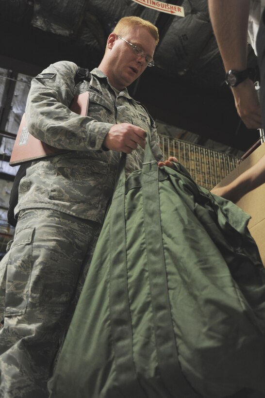 Senior Airman Samuel Jones, 11th Wing Judge Advocate paralegal, receives gear in
the processing line during an Operational Readiness Exercise at Joint Base Andrews, Md., on June 7. The exercise demonstrated the 11th Wing's capability to deploy Airmen anywhere in the world at a moment's notice. (U.S. Air Force photo/Airman 1st Class Aaron Stout)