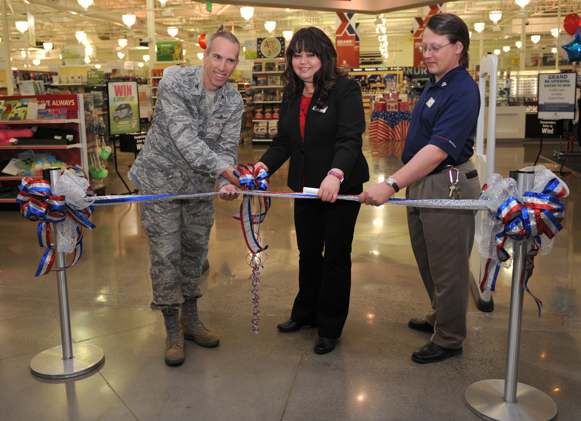 U.S. Air Force Col. Scott Moser, 366th Mission Support Group commander, cuts a ribbon during the grand re-opening of the Base Exchange, June 15, 2012, at Mountain Home Air Force Base, Idaho. The renovation, an investment that exceeded $7 million, was started in October 2011, and included new polished floors, carpets, paint and upgraded fixtures. (U.S. Air Force photo by Airman 1st Class Heather Hayward/Released)