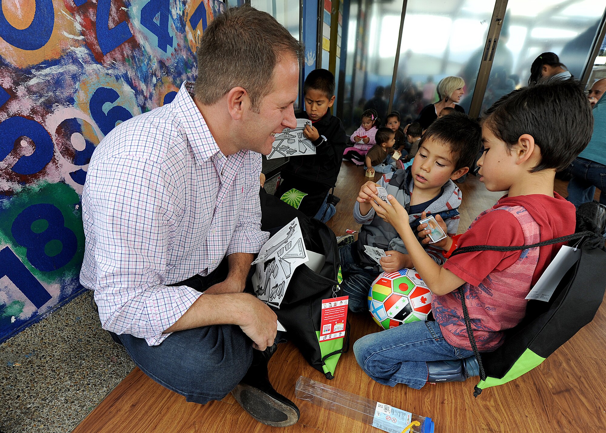Lieutenant Col. Gabe Griess, 571st Mobility Support Advisory Squadron director of operations, spends time with children from the Asociación Amigos del Niño Ayudame, Bogota, Colombia June 9 as part of an Air Mobility Command Building Partner Capacity month-long mission.  Members of the Colombian air force, Inter-American Air Forces Academy and 12th Air Force (Air Forces Southern) also participated in the visit.  (U.S. Air Force photo by Tech. Sgt. Lesley Waters)