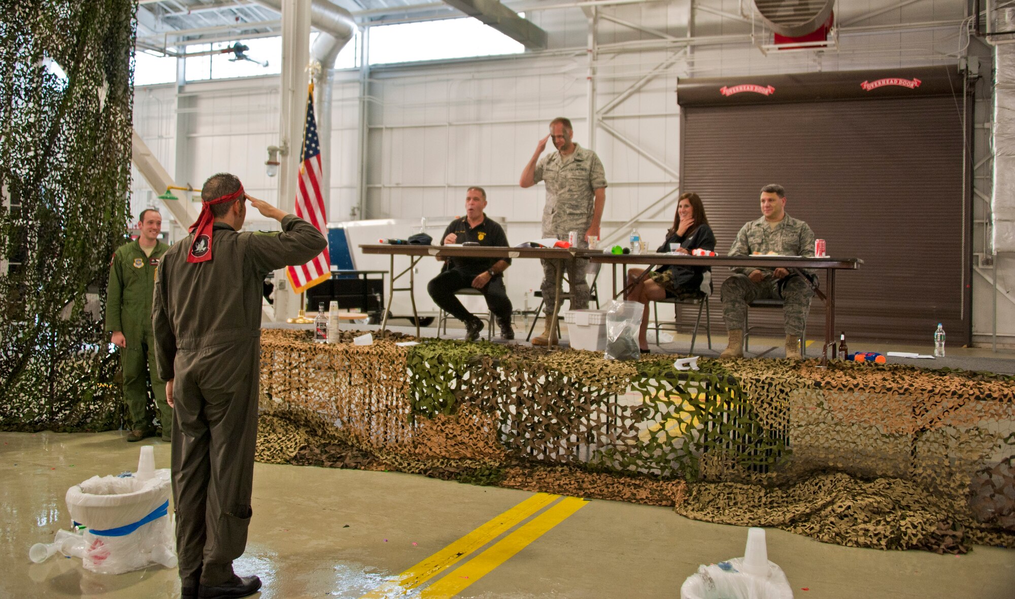 Lt. Col. Brent Mesquit, 2nd Air Refueling Squadron commander, salutes Col. John Roscoe, 305th Operations Group commander, as he arrives to the grog bowl during the 305th OG combat dining in at Hangar 23 June 8. About 120 members of the 305th OG attended the event. (U.S. Air Force photo by Staff Sgt. David Carbajal/Released)