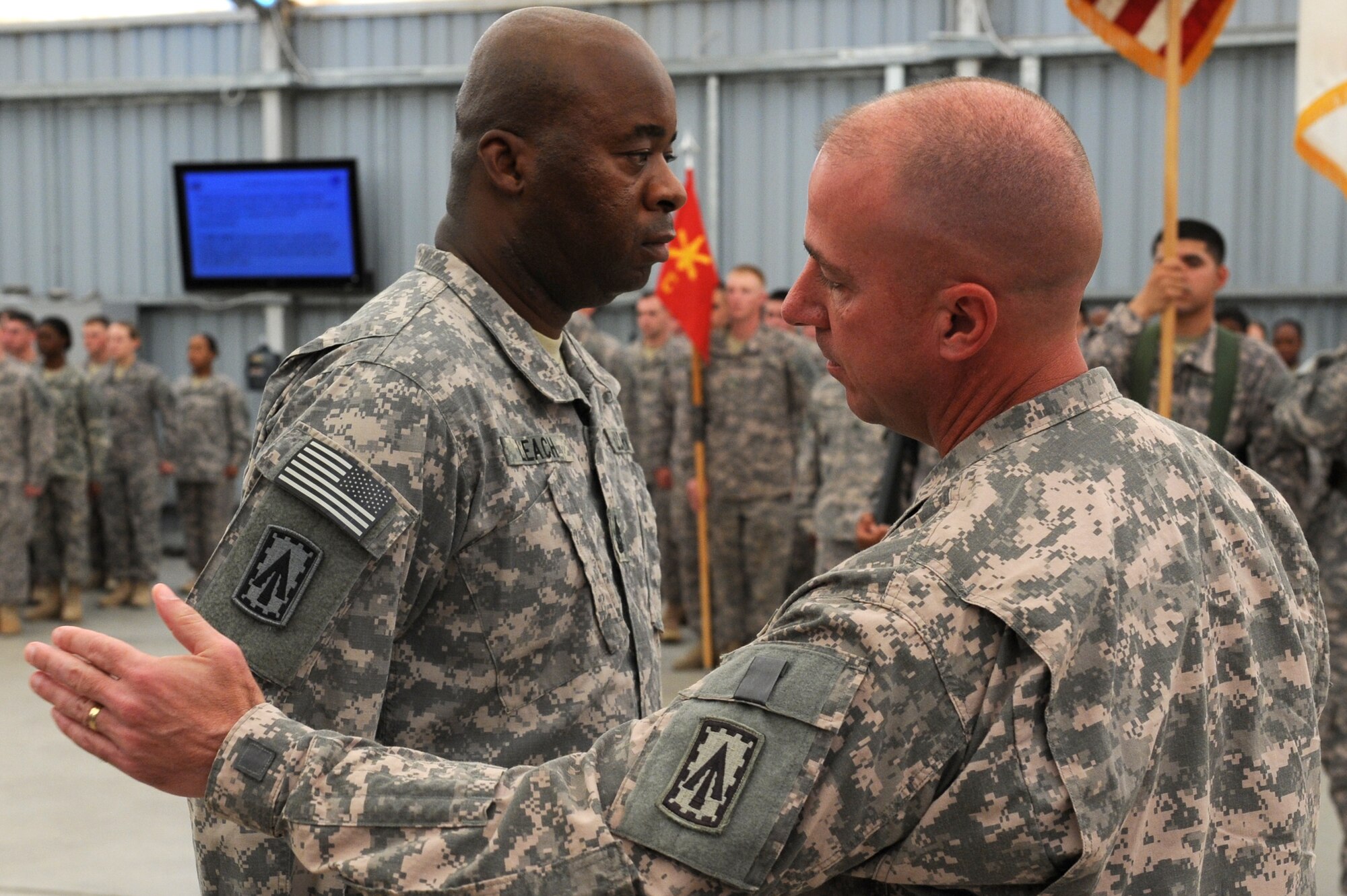 SOUTHWEST ASIA - Lt. Col. David Baxter, 1st Battalion, 7th Air Defense Artillery Regiment commander, patches Command Sgt. Maj. Micheal Leach during their patching ceremony at the 380th Air Expeditionary Wing June 14, 2012. The unit, deployed from Ft. Bragg N.C., conducted its patching ceremony in conjunction with the U.S. Army's 237th birthday.  (U.S. Air Force photo/Master Sgt. Scott MacKay)