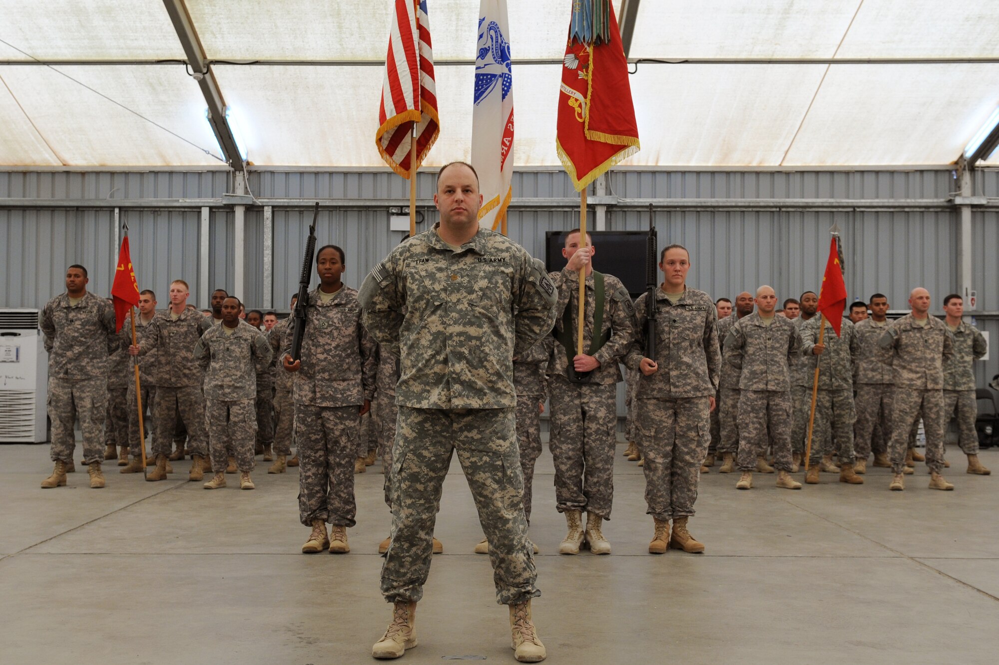 SOUTHWEST ASIA - The U.S. Army 1st Battalion, 7th Air Defense Artillery Regiment Color Guard stands at parade rest before the start of their patching ceremony at the 380th Air Expeditionary Wing June 14, 2012. The unit, deployed from Ft. Bragg N.C., conducted its patching ceremony in conjunction with the U.S. Army's 237th birthday. (U.S. Air Force photo/Master Sgt. Scott MacKay)