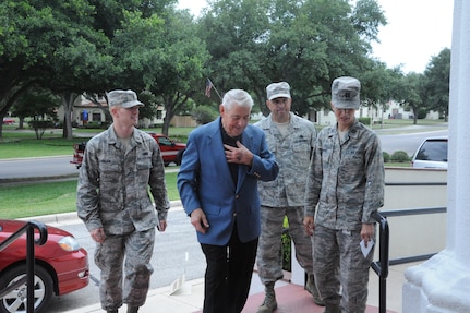 Chief Master Sgt. (ret) Robert Gaylor, 5th Chief Master Sgt. of the Air Force is greeted by (from left to right) 2nd Lt. Bryan Fagan, Chie Master Sgt. Edwin Olan and Capt. Heather Simone, Air Force Personnel Center, as he arrives at the Joint Base San Antonio-Randolph,Texas, theater June 14. Chief Gaylor spoke to JBSA-Randolph personnel about leadership. (U.S. Air Force photo by Rich McFadden) 