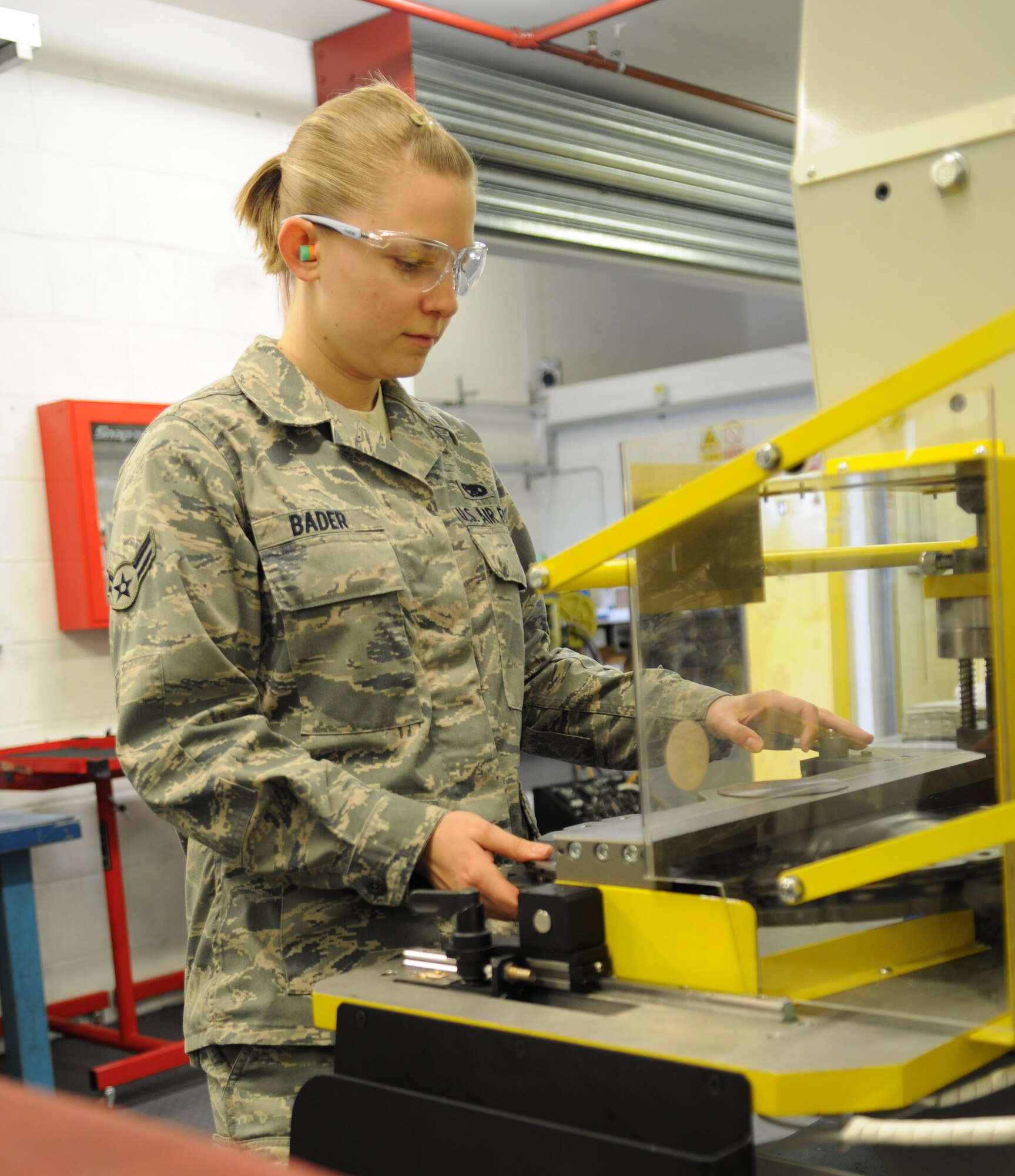 RAF MILDENHALL, England – Airman 1st Class Brandy Bader, 100th Maintenance Squadron aircraft hydraulics journeyman, attaches stator plates to a MC-130 Combat Shadow brake using a BrakeMaster Aircraft Brake Servicing Press, June 12, 2012, at the hydraulics shop. The machine reduces the amount of time it takes to service a brake from eight hours by hand to 30 minutes. (U.S. Air Force photo/Senior Airman Rachel Waller)  
