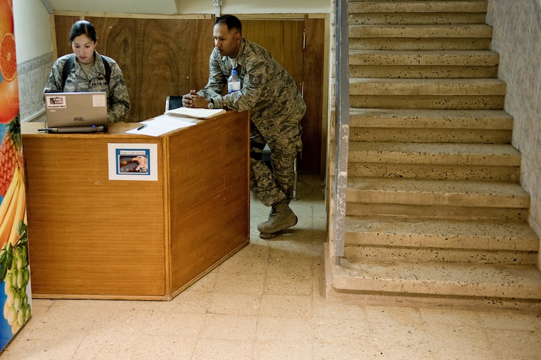 Tech. Sgt. Ivan Prakash (right) and Senior Airman Deborah Vives with the Office of Security Cooperation - Iraq Financial Management team, set up a work station June 6 in Taji, Iraq. The OSC - I FM team travels to several sites in Iraq helping U.S. military personnel and civilian contractors with EagleCash and cash operations, setting up a new way to conduct financial services after the 2011 Armed Forces drawn down.  (U.S. Air Force photo by Staff Sgt. Greg C. Biondo)