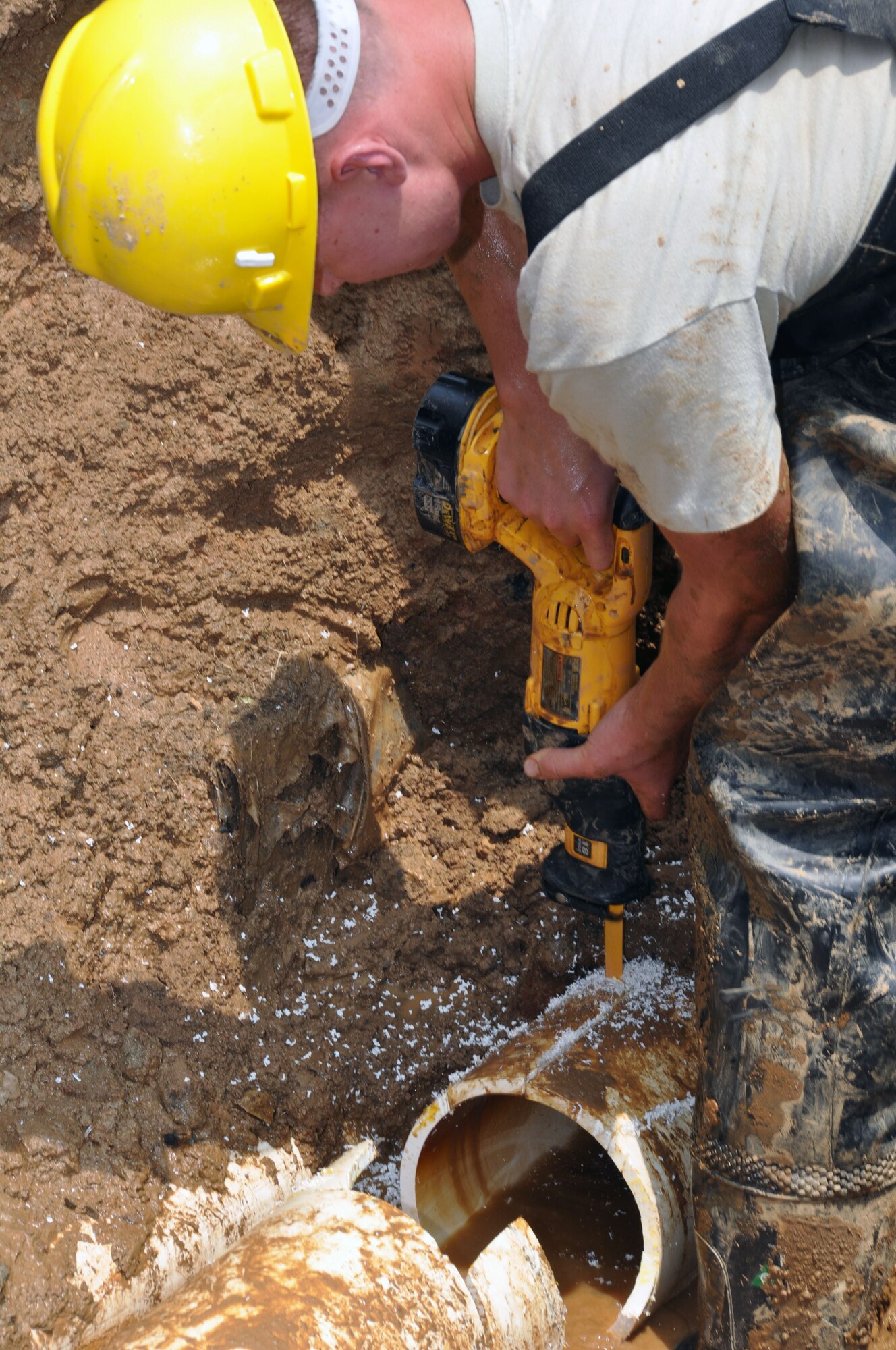 Airman 1st Class Jacob Stratton, 51st Civil Engineer Squadron water and fuel maintainer, cuts into a damaged water pipe to make room for a replacement June 14, 2012, at Osan Air Base, Republic of Korea. Water and fuel maintainers ensure the water supply to dorms, offices and housing at Osan remains in good working order. (U.S. Air Force photo/Senior Airman Michael Battles)