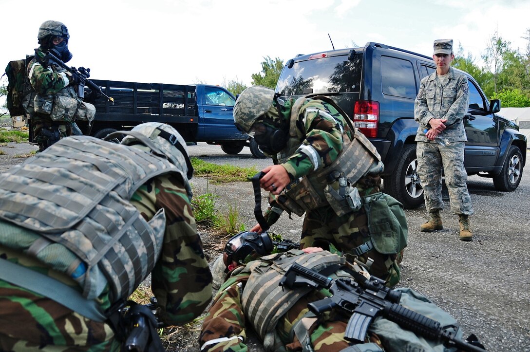 The 36th Contingency Response Group Airmen perform self aid and buddy care on a simulated unconscious Airman after a chemical attack scenario during an exercise at Northwest field, Guam, June 6. The 36 CRG conducted a four-day exercise in order to hone their tactical skills, improve operational readiness and prepare for an upcoming unit compliance inspection. (U.S. Air Force photo by Airman 1st Class Marianique Santos/Released)