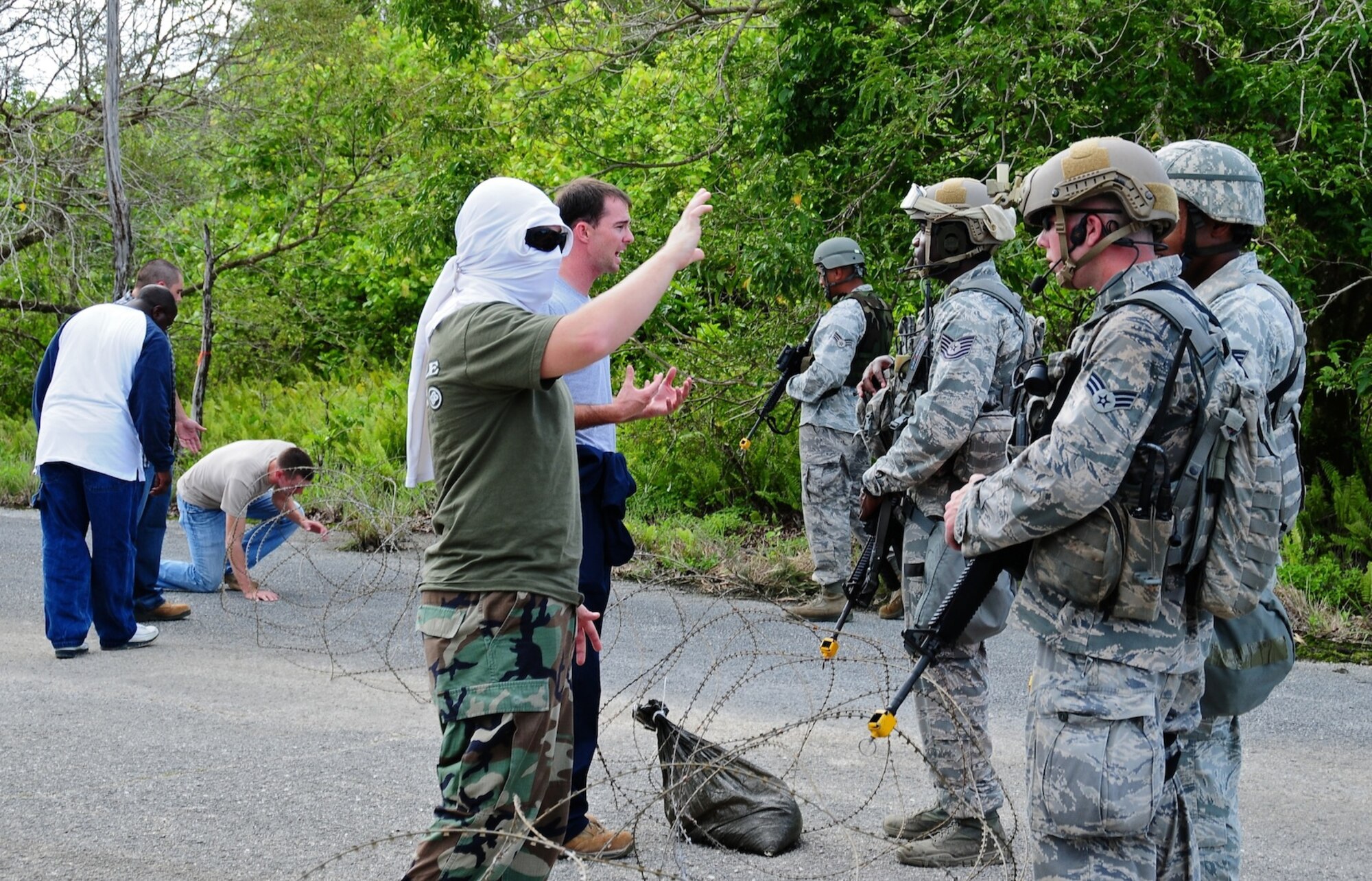 The 36th Contingency Response Group entry control point security listens to “protestor” concerns during an exercise scenario at Northwest field, Guam, June 6. The 36 CRG conducted a four-day exercise in order to hone their tactical skills, improve operational readiness and prepare for an upcoming unit compliance inspection. (U.S. Air Force photo by Airman 1st Class Marianique Santos/Released)