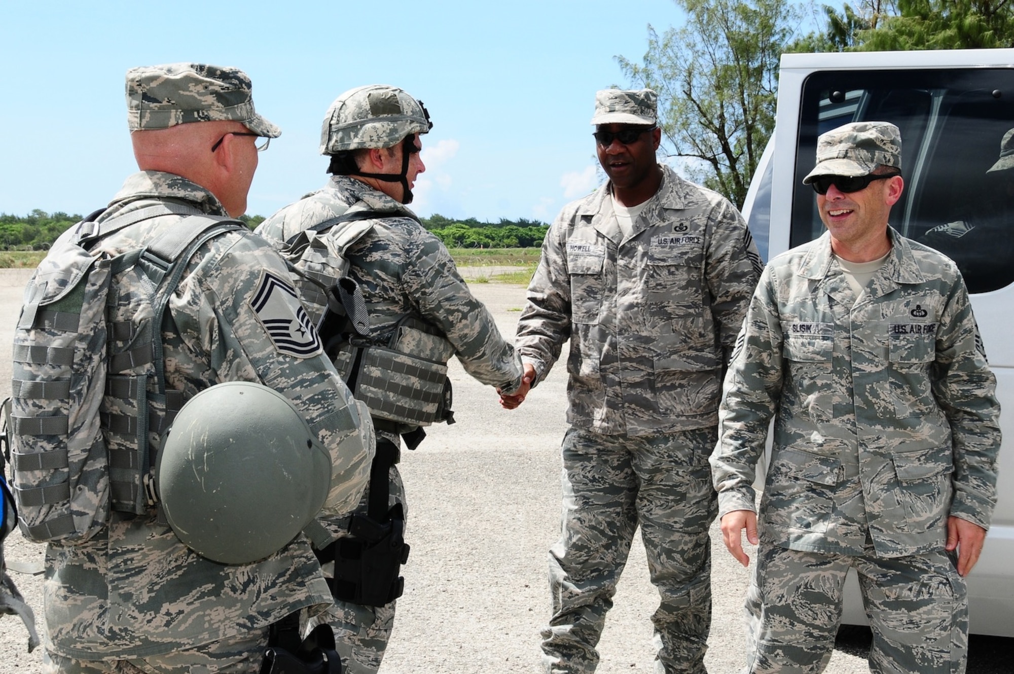 Lt. Col. Michael Black, 36th Mobility Response Squadron commander, and Senior Master Sgt. Rick Schlachter, 736th Security Forces squadron senior enlisted advisor to the site commander, welcomes Chief Master Sgt. James Slisik, 36th Wing command chief, and Chief Master Sgt. Joseph Howell, 36th Contingency Response Group superintendent, along with the other senior noncommissioned officers visiting the exercise site at Northwest Field, Guam, June 6. The 36th Contingency Response Group conducted a four-day exercise in order to hone their tactical skills, improve operational readiness and prepare for an upcoming unit compliance inspection. (U.S. Air Force photo by Airman 1st Class Marianique Santos/Released)