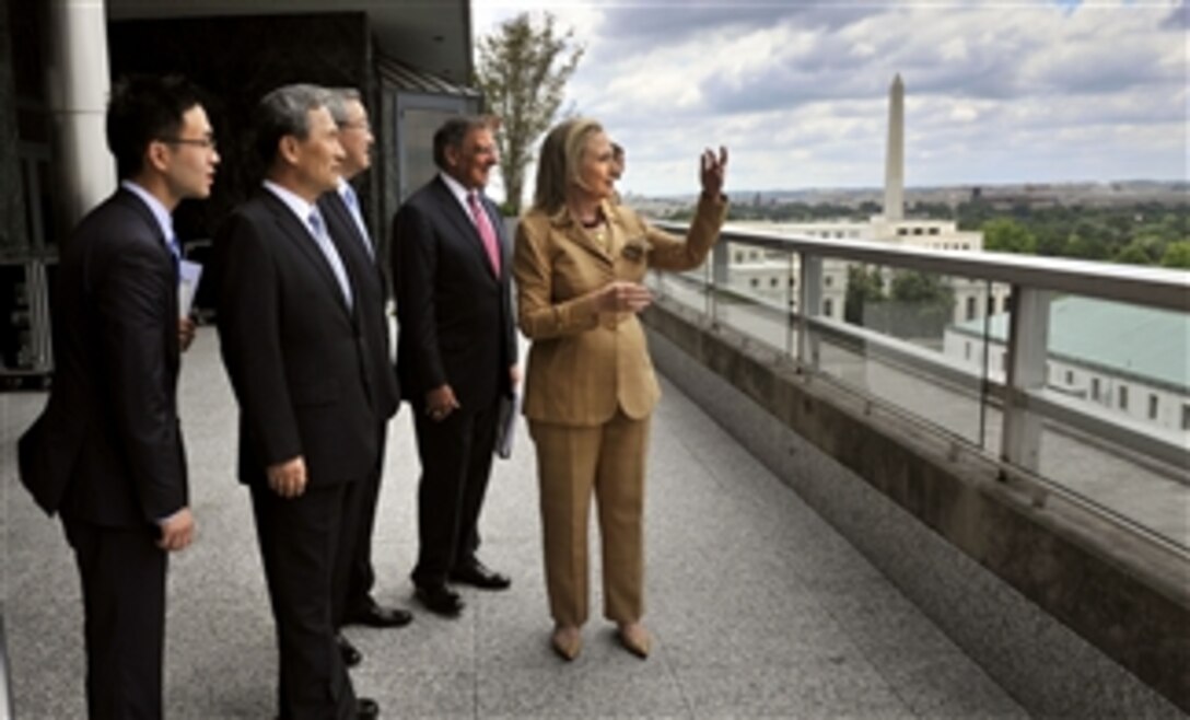 Secretary of State Hillary R. Clinton and Secretary of Defense Leon E. Panetta show their South Korean counterparts Minister of Foreign Affairs and Trade Kim Sung Hwan and Minister of Defense Kim Kwan-jin a view of the U.S. Capitol city from the eighth floor of the U.S. Department of State in Washington, D.C., on June 14, 2012. 