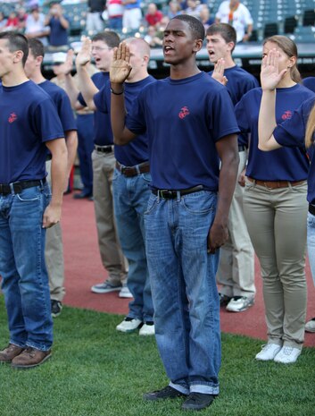 Aaron Johnson, a poolee with Recruiting Sub-Station Maple Heights, takes the oath of enlistment with fellow greater Cleveland area poolees during Marine Night before the Cleveland Indians took on the Pittsburgh Pirates at Progressive Field June 15, during Marine Week Cleveland, which ends June 17. Brig. Gen. Joseph L. Osterman, Marine Corps Recruiting Command commanding general, swore in the soon-to-be Marine recruits. Then the Marine Corps Base Quantico Band performed, the Holy Angels Church Choir sang the National Anthem and Sgt. Maj. of the Marine Corps Micheal P. Barrett threw the first pitch of the game.