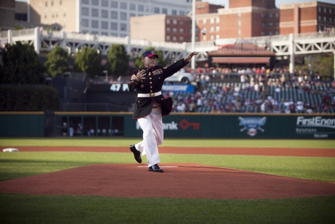 Sgt. Maj. Micheal P. Barrett, sergeant major of the Marine Corps, throws the first pitch for Marine Night at the Cleveland Indians game here, June 15, 2012, during Marine Week Cleveland. Outside the stadium, Marine Corps vehicles, aircraft and equipment were available for public viewing at the Gateway Plaza. Public Square, Voinovich Park, and Rock and Roll Hall of Fame are some of other venues that displayed equipment as well. Marine Week Cleveland celebrates community, country and the Corps. More than 750 Marines journeyed to Cleveland for the event. Ohio has more than 9,000 active and reserve Marines, making it one of the top-five producers of Marines. The culminating event for the week is the Marine Air-Ground Task Force demo, June 16-17, in which Marines will invade the Burke Lakefront Airport by land, air, and sea. (U.S. Marine Corps Photo by Cpl. Marcin Platek)::r::::n::