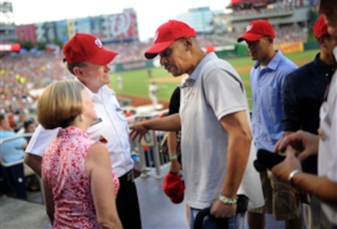 Army Gen. Martin E. Dempsey, chairman of the Joint Chiefs of Staff, and his wife Deanie, talk with a wounded warrior at the Washington Nationals baseball game against the New York Yankees in Washington, D.C., June 15, 2012.  
