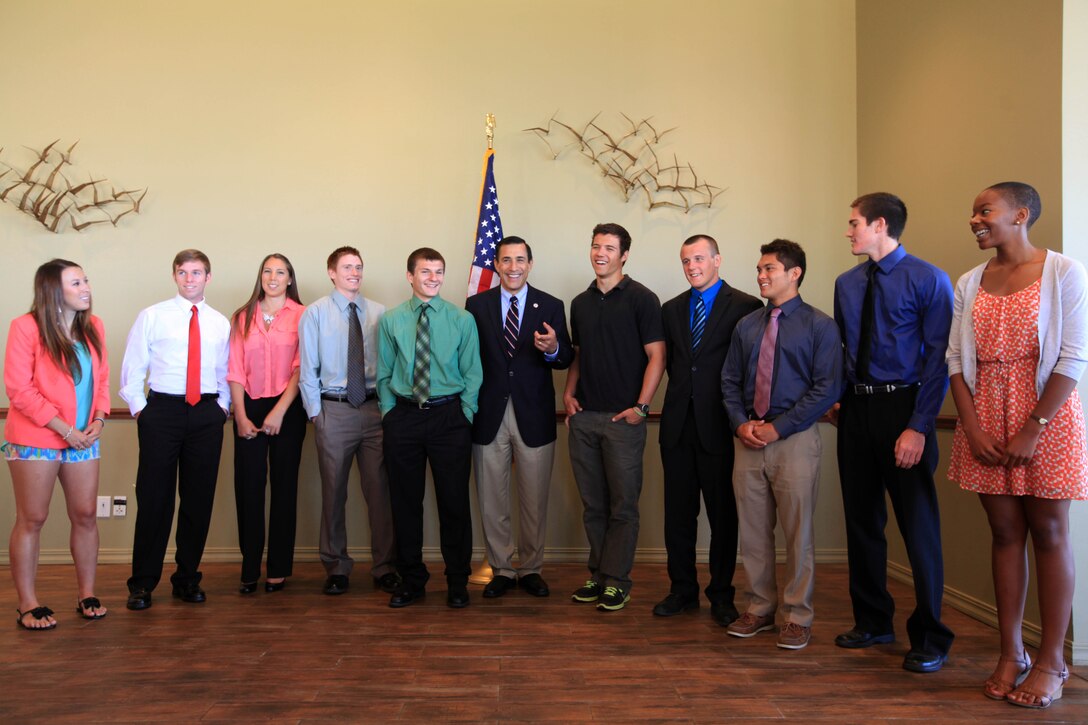(Left to right) Kaylie Davidson, David Higgins, Jennifer Chavez, Daniel Thompson, Jacob Cole, Congressman Darrell Issa, Ian Shaw, Dylan Smith, Nicholas Villemez, Connor Colas, and Amy Nyago-Ogelsby prepare to take a group photograph after the Service Academy breakfast held at the Pacific Views Event Center on Marine Corps Base Camp Pendleton, June 16. These 10 academy appointees will attend the Naval Academy, West Point, and the Air Force Academy for the next four years in order to become officers in the United States military.