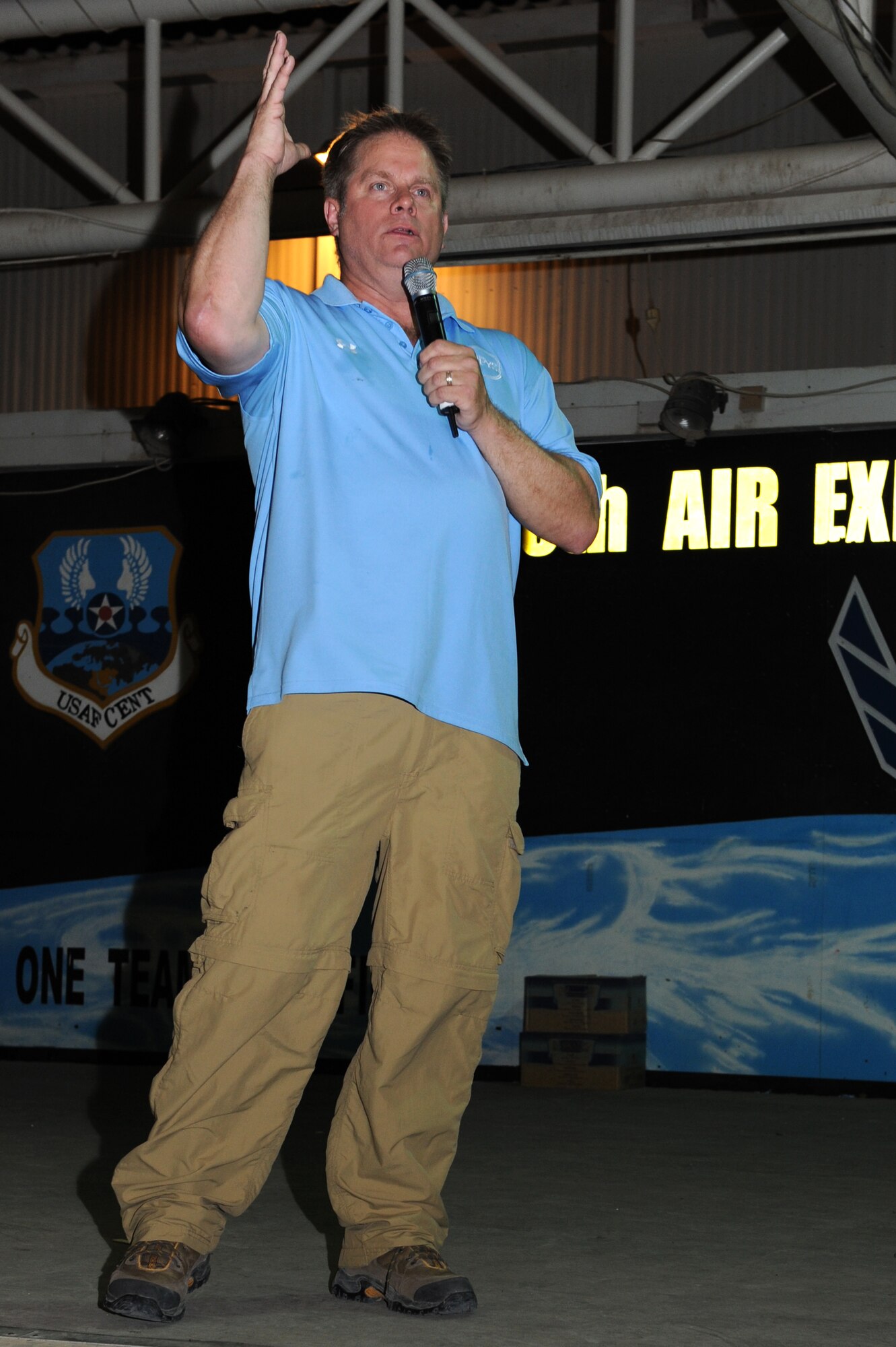 SOUTHWEST ASIA - - Comic Steve Bills performs for the 380th Air Expeditionary Wing June 15, 2012. Bills is part of a five-man comedy team touring the region as part of an Armed Forces Entertainment program to boost troop morale. (U.S. Air Force photo/Master Sgt. Scott MacKay)