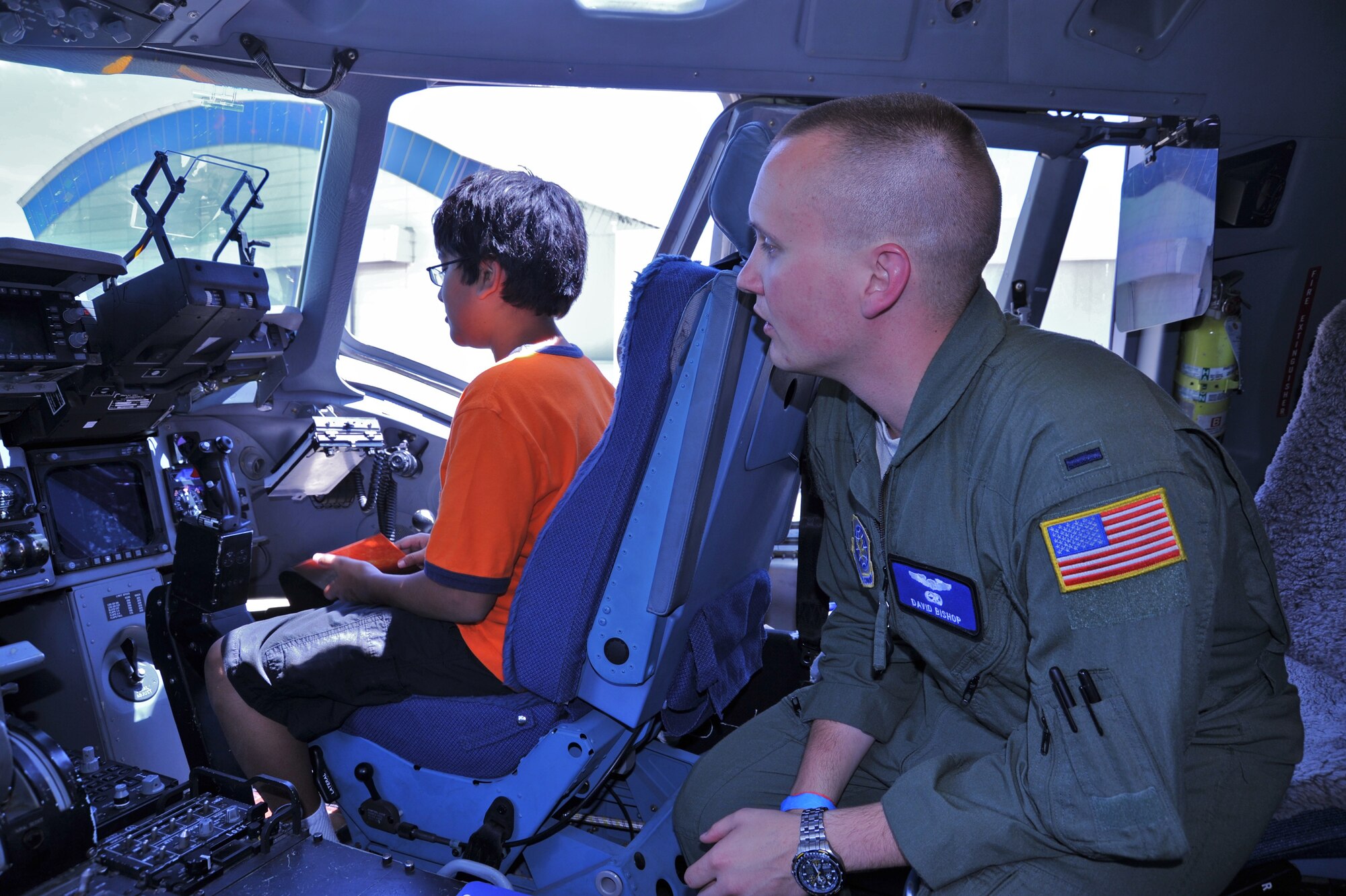 1st Lt. David Bishop explains the heads-up display of a C-17 Globemaster to Kiron Khashnobish, 12, at "Become a Pilot Day" near Chantilly, Va., June 16, 2012. Become a Pilot Day is an annual event at the National Air and Space Museum, intended to introduce children to careers in aviation. (U.S. Air Force photo/Airman 1st Class Alexander W. Riedel)
