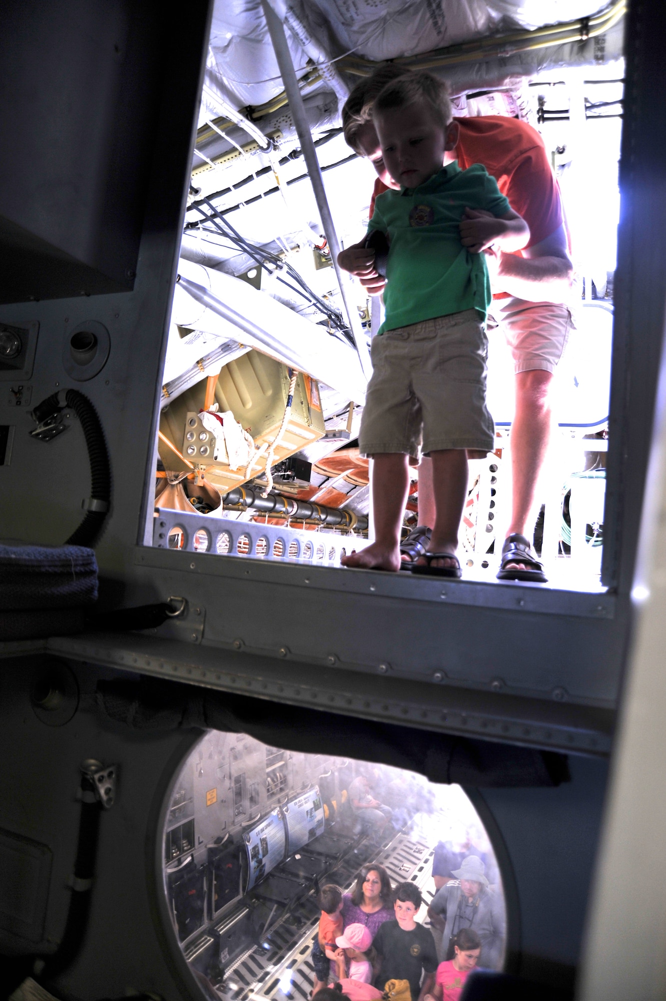 A father guides his son back into the flight deck of a C-17 Globemaster, near Chantilly, Va., June 16, 2012.  Become a Pilot Day is an annual event held at the National Air and Space Museum's Udvar-Hazy Center. (U.S. Air Force photo/Airman 1st Class Alexander W. Riedel)