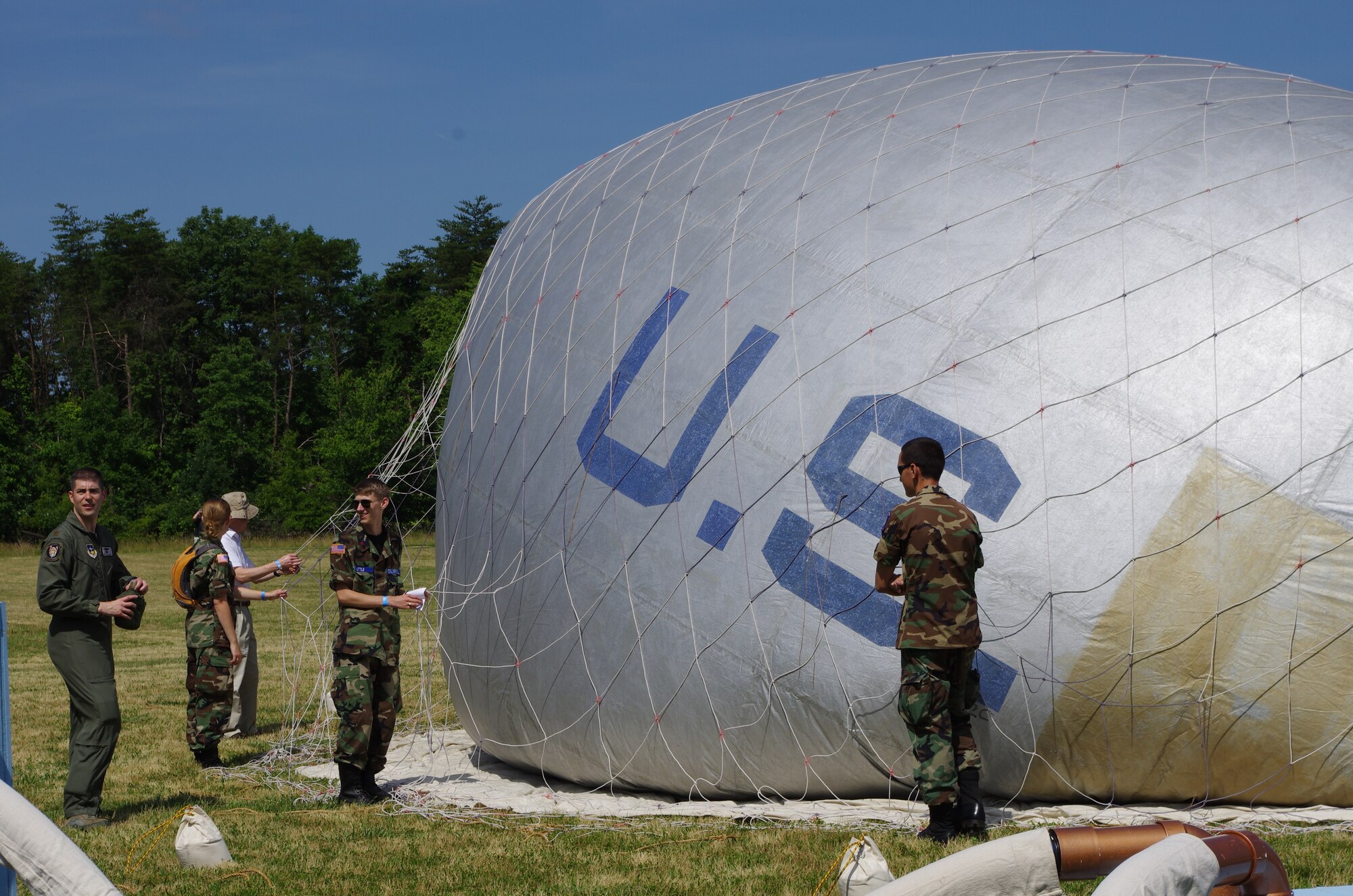 Maj. Nathan McClure, an Air Force Fellow with the Department of Transportation, guides his team of Civil Air Patrol cadets in the inflation of a Civil-War era balloon near Chantilly, Va., June16, 2012. "Become a Pilot Day" at the National Air and Space Museum is an annual event informing children and students about aviation and aircraft. (U.S. Air Force Photo/Staff Sgt. Ashley Riedel)