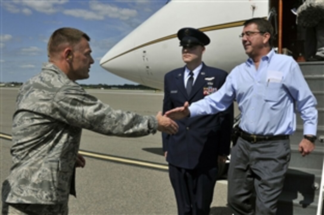 Deputy Defense Secretary Ashton B. Carter, right, shakes hands with Air Force Col. Richard D. McComb, 628th Air Base Wing, as he arrives on Joint Base Charleston, S.C., June 17, 2012.