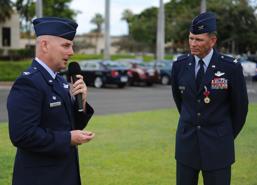 Col. Joe Dague, 15th Wing vice commander (right), listens as Col. Sam Barrett, 15th WG commander, speaks to Airmen from the 15th WG during Dague's Legion of Merit presentation ceremony June 15 at Joint Base Pearl Harbor-Hickam, Hawaii. The Legion of Merit decoration is presented to officers and enlisted men of the Armed Forces of the United States and on nationals of other counties who have distinguished themselves by exceptionally meritorious conduct in the performance of outstanding services and achievements.