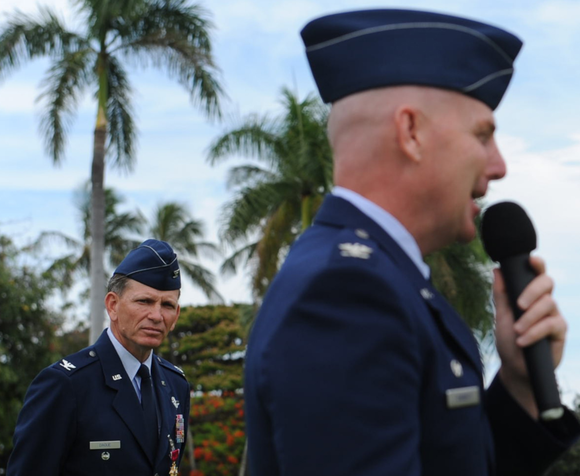 Col. Joe Dague, 15th Wing vice commander (left), listens as Col. Sam Barrett, 15th WG commander, speaks to Airmen from the 15th WG during Dague's Legion of Merit presentation ceremony June 15 at Joint Base Pearl Harbor-Hickam, Hawaii. The Legion of Merit decoration is presented to officers and enlisted men of the Armed Forces of the United States and on nationals of other counties who have distinguished themselves by exceptionally meritorious conduct in the performance of outstanding services and achievements.