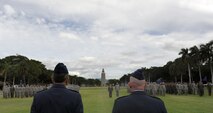 Col. Joe Dague, 15th Wing vice commander (left), and Col. Sam Barrett, 15th WG commander, stand in front of members of the 15th WG during Dague's Legion of Merit presentation ceremony June 15 at Joint Base Pearl Harbor-Hickam, Hawaii. The Legion of Merit decoration is presented to officers and enlisted men of the Armed Forces of the United States and on nationals of other counties who have distinguished themselves by exceptionally meritorious conduct in the performance of outstanding services and achievements.