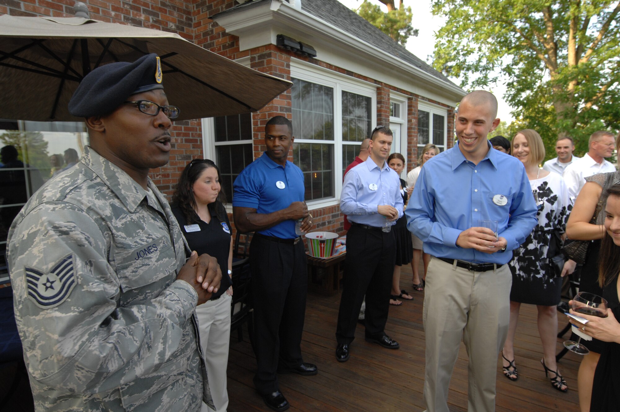 SHAW AIR FORCE BASE, S.C. - U.S. Air Force Tech. Sgt. Jemal Jones, a native of Jacksonville, N.C. and the military working dog kennel master for the 20th Security Forces Squadron, Shaw Air Force Base, S.C. enlightens members of the Young Professionals of Sumter and Shaw’s Company Grade Officers, while at the home of 9th Air Force Commander, Maj. Gen. Lawrence L. Wells June 14, 2012 for dinner and an opportunity establish new relationships between one another.  (U.S.  Air Force photo by Master Sgt. Cohen A. Young/Released)