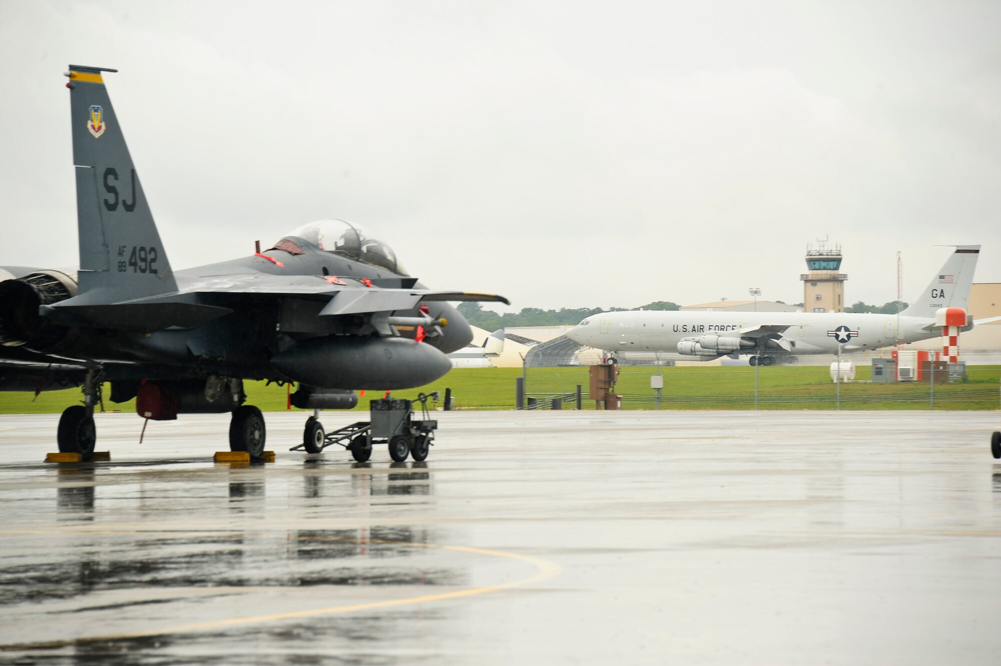 An E-8 Joint STARS takes off down the runway past an F-15E Strike Eagle during a sortie while participating in exercise Iron Dagger 2012, Robins Air Force Base, Ga., June 11, 2012.  The Strike Eagles came to Robins from Seymour Johnson Air Force Base to participate in the week long exercise.
(National Guard photo by Master Sgt. Roger Parsons/Released)
