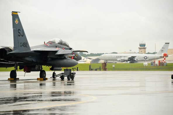 An E-8 Joint STARS takes off down the runway past an F-15E Strike Eagle during a sortie while participating in exercise Iron Dagger 2012, Robins Air Force Base, Ga., June 11, 2012.  The Strike Eagles came to Robins from Seymour Johnson Air Force Base to participate in the week long exercise.
(National Guard photo by Master Sgt. Roger Parsons/Released)
