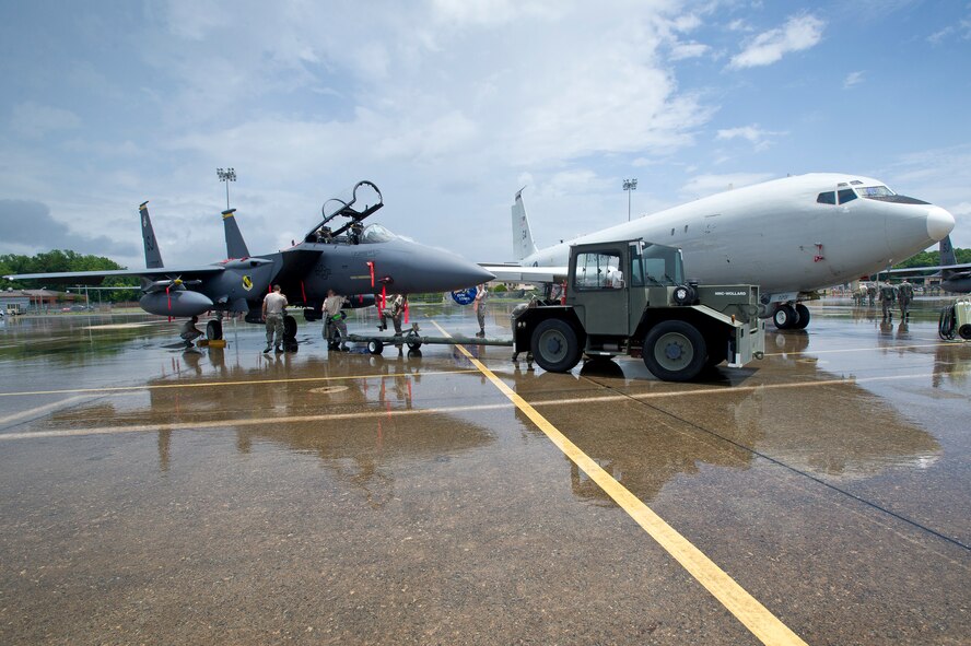 F-15E Strike Eagle crew chiefs from the 4th Fighter Wing, Seymour Johnson, N.C., position their jet next to an E-8 Joint STARS. The 4th Fighter Wing was at Robins to participate in exercise Iron Dagger 2012 with Team JSTARS. Prior to the start of the exercise, one E-8 and two F-15Es were set up for a group photo to commemorate the exercise. (U.S. Air Force photo by Master Sgt. Roger Parsons)