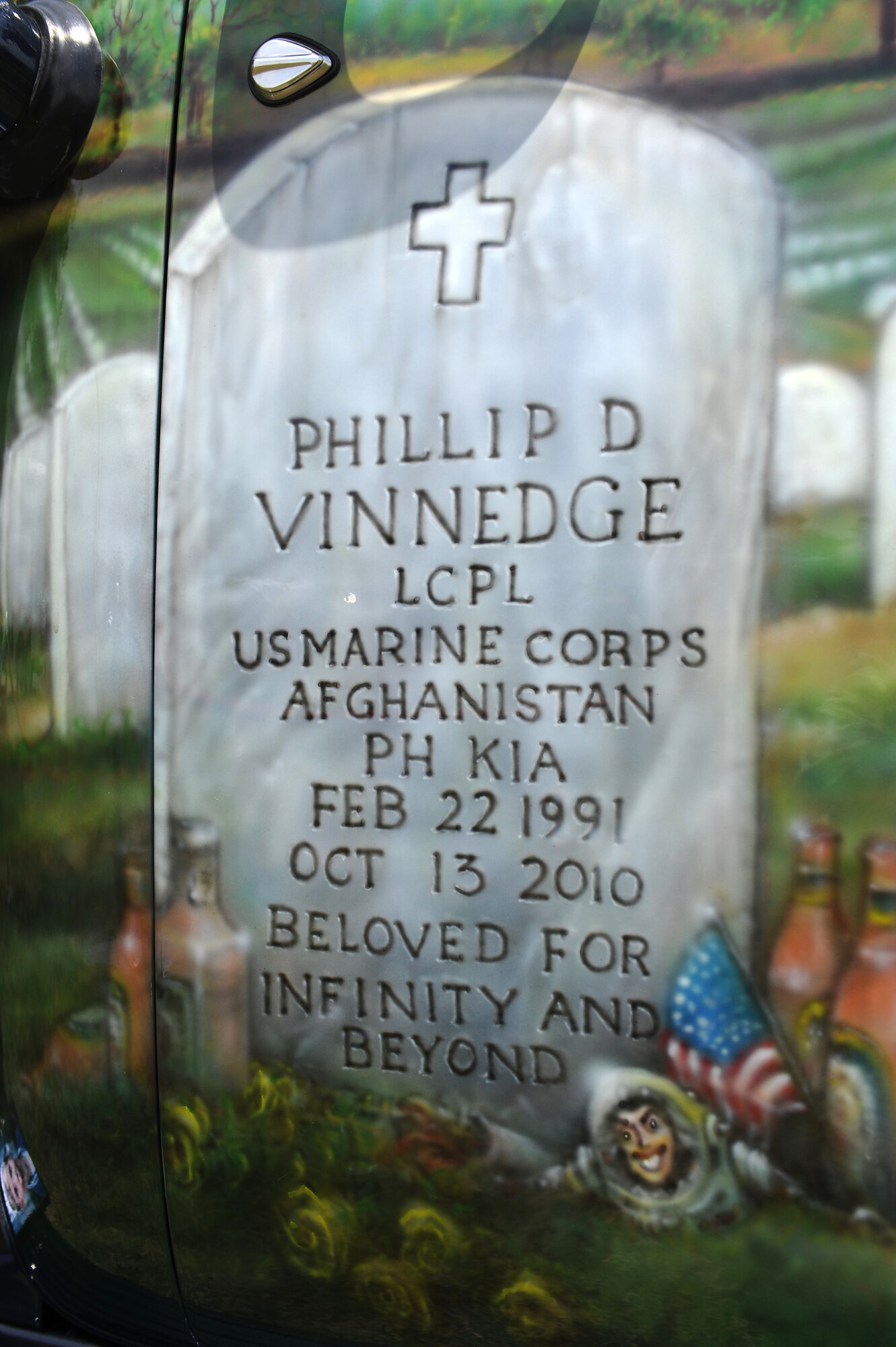 A graphic illistraton of fallen Lance Cpl. Phillip Vinnedge is on display at the Fallen Hero's Dream Ride during a display at the base wide picnic on Scott Air Force Base, Ill. June 15 , 2012. Fallen Hero's Dream Ride was formed by Cory Vinnedge after the death of his brother Lance Cpl. Phillip Vinnedge who was killied in action while serving in Afghanistan. The goal of Fallen Hero's Dream ride is to create a rolling memorial to build awareness of the sacrifices our fallen military men and women have made, and to encourage support of related not for profit organizations. (U.S. Air Force photo/2nd Lt. Korey Fratini)