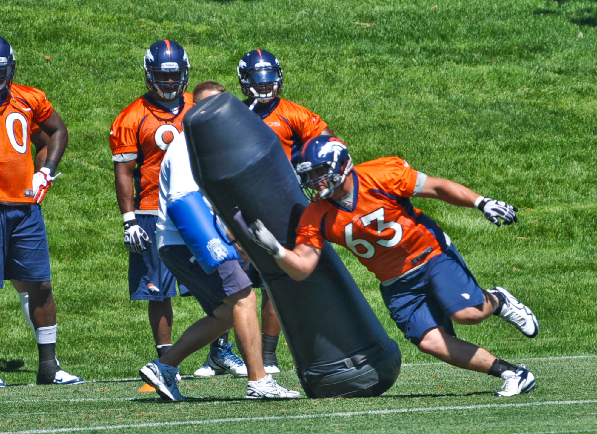 ENGLEWOOD, Colo. – Benjamin Garland makes his way around a “dummy bag” during a Denver Broncos mini-camp session June 13, 2012. Garland participated in the three-day mini-camp which took place from June 12-14. He is currently assigned to the 140 Wing Public Affairs Office, Colorado Air National Guard. (U.S. Air Force photo by Senior Airman Christopher Gross)