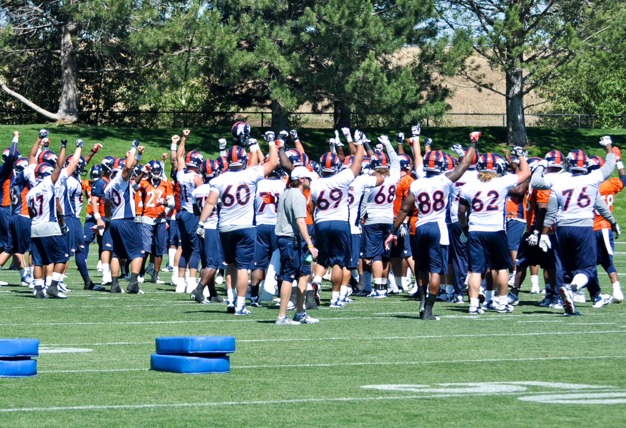 ENGLEWOOD, Colo. – Denver Bronco players huddle during a mini-camp session June 13, 2012. Benjamin Garland, a member of the Broncos and 140 Wing Public Affairs Office, Colorado Air National Guard, received an offer from the Broncos after graduating with the Air Force Academy Class of 2010. (U.S. Air Force photo by Senior Airman Christopher Gross)